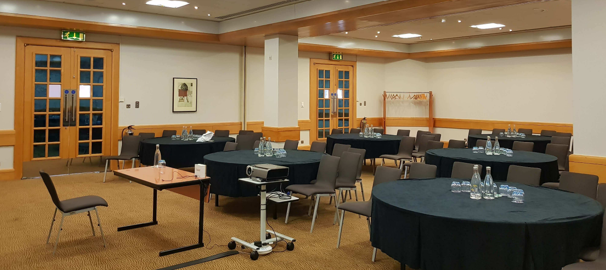 Victoria Suite meeting room at Novotel Bristol, set for a conference with circular tables.