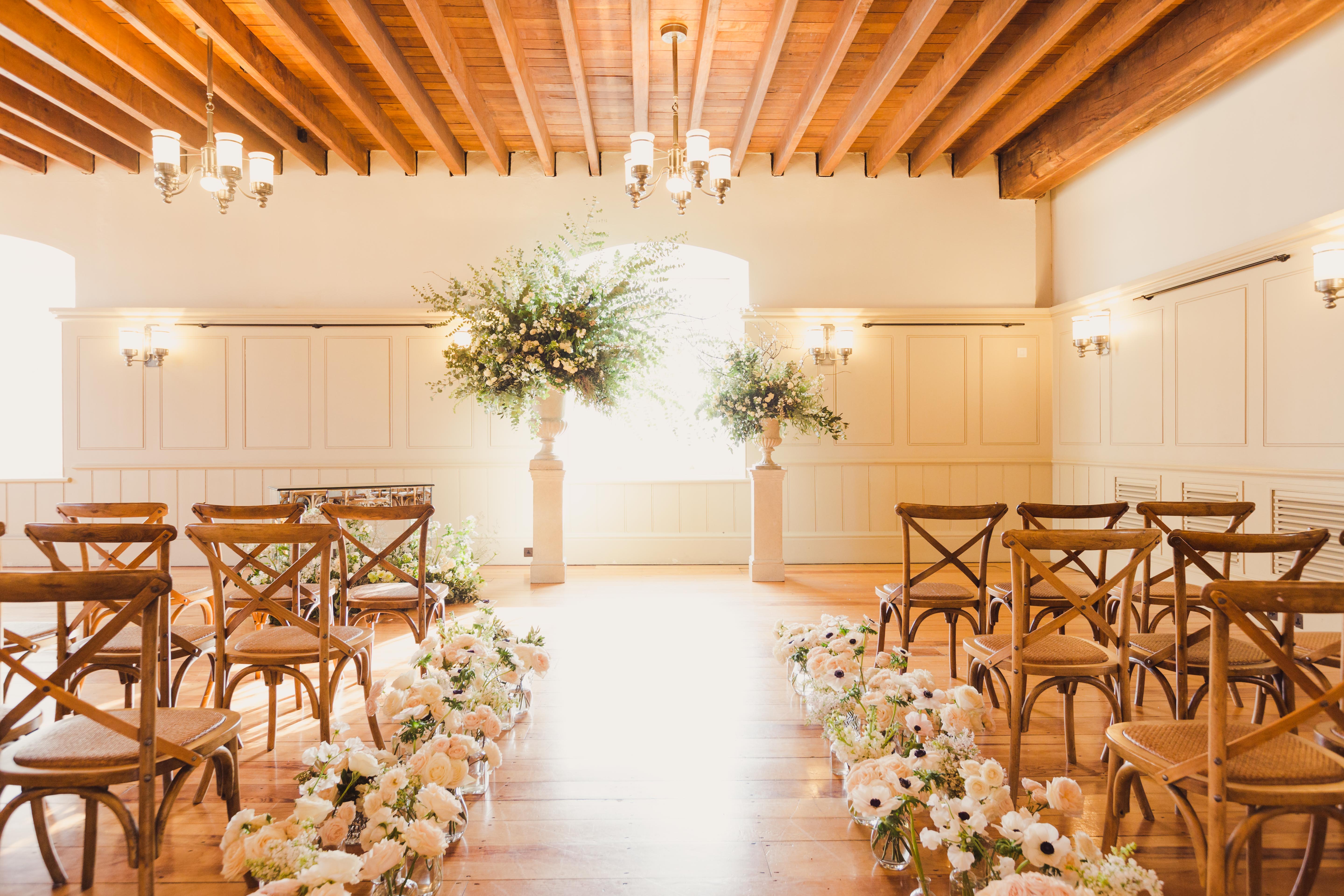 New Armouries wedding venue with elegant wooden beams and floral arrangements.