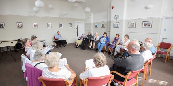 Milford Hall meeting space with seniors in choir session, ideal for community events.