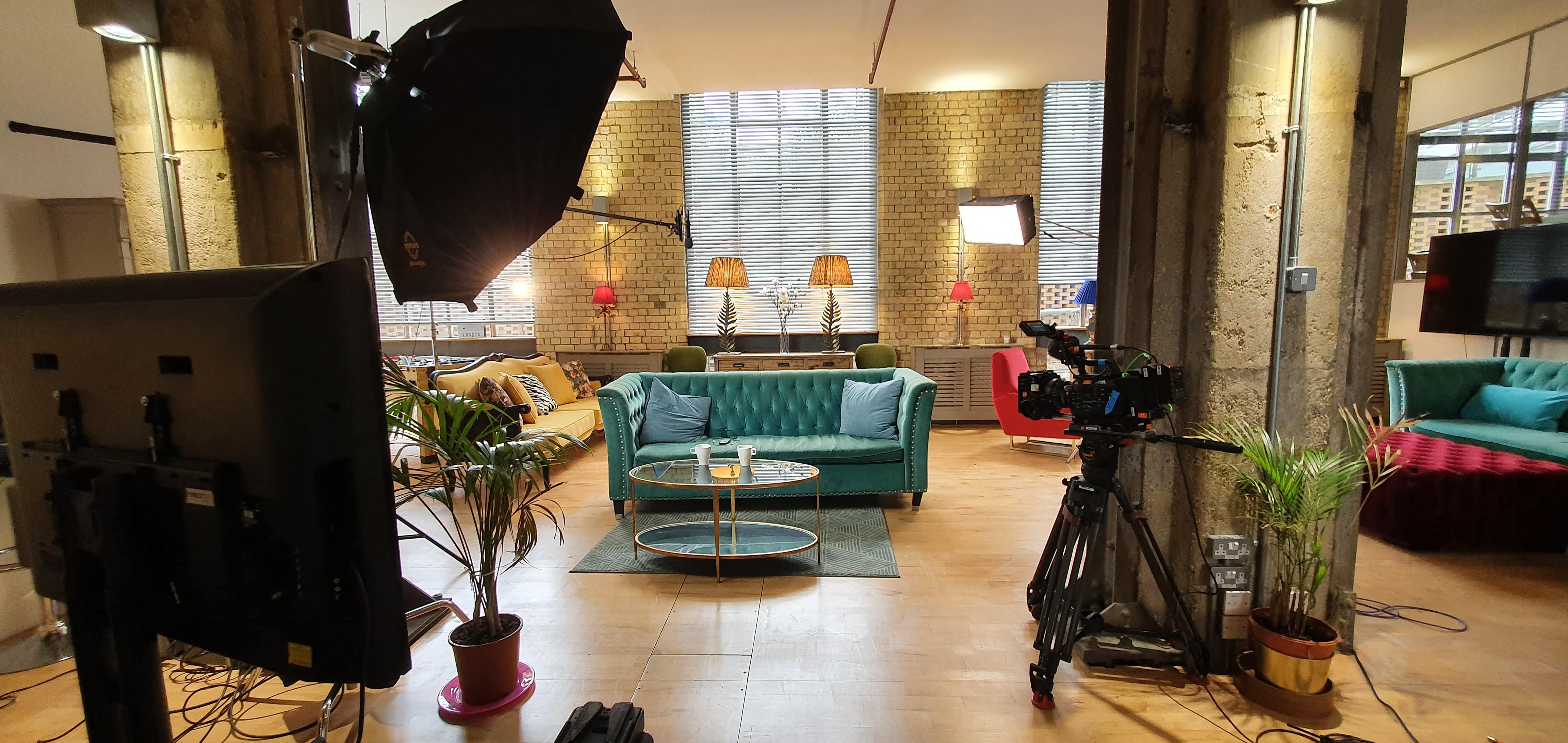The New Yorker Gallery event space with teal sofa, ideal for video shoots and meetings.