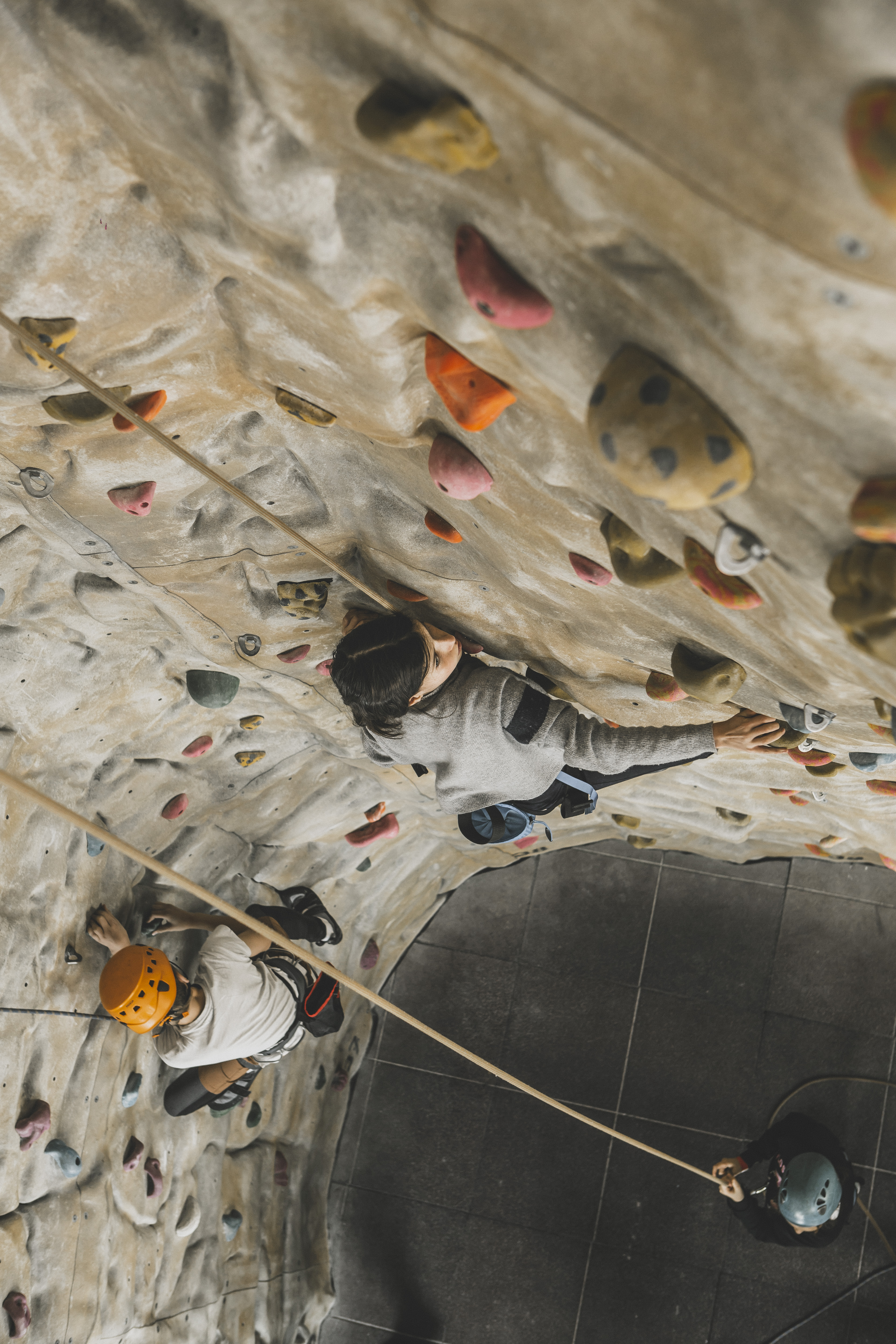 Climber on rock wall at Westway Sports & Fitness Centre for team-building events.