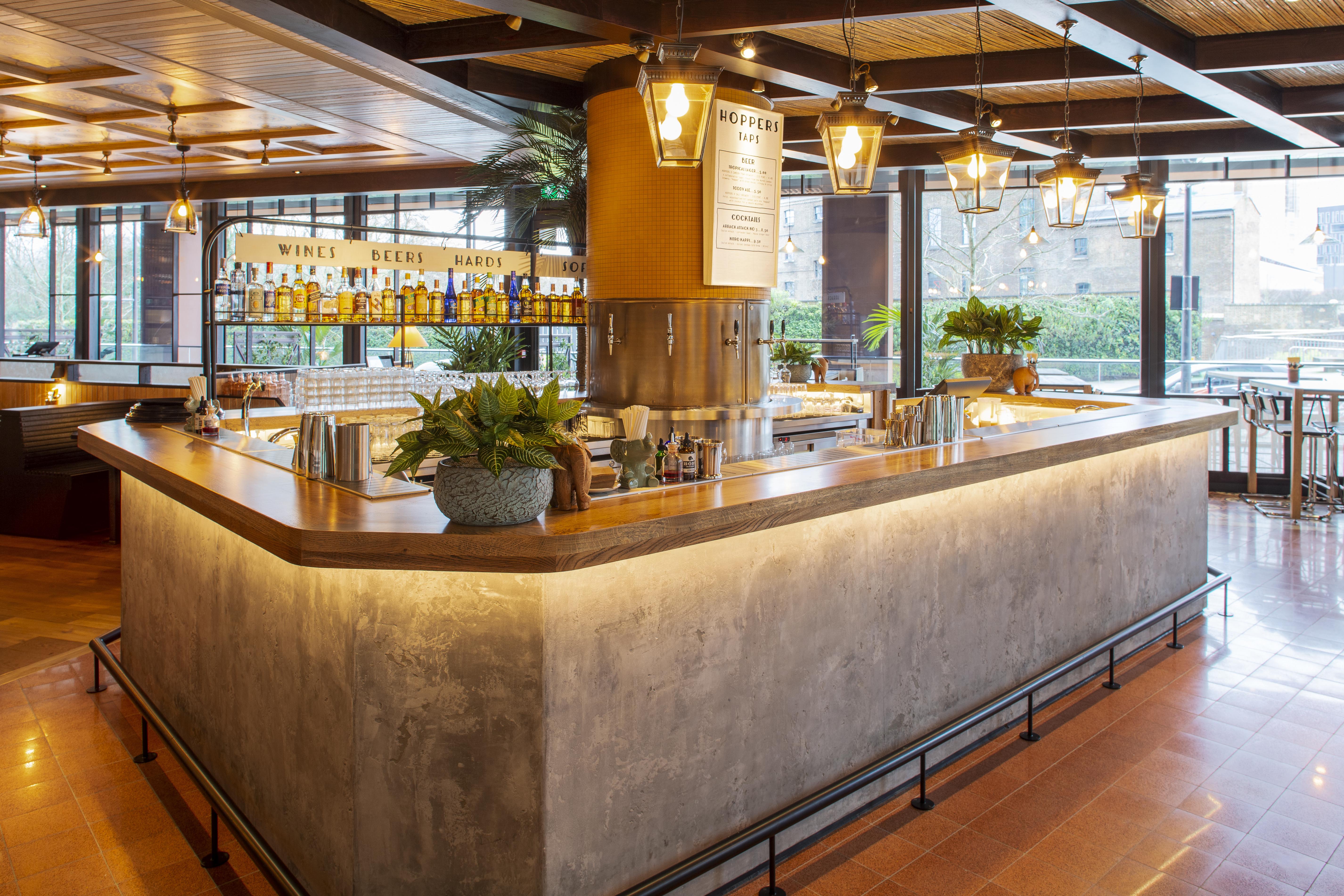 Modern bar in Hoppers King's Cross with sleek counter, ideal for networking events.