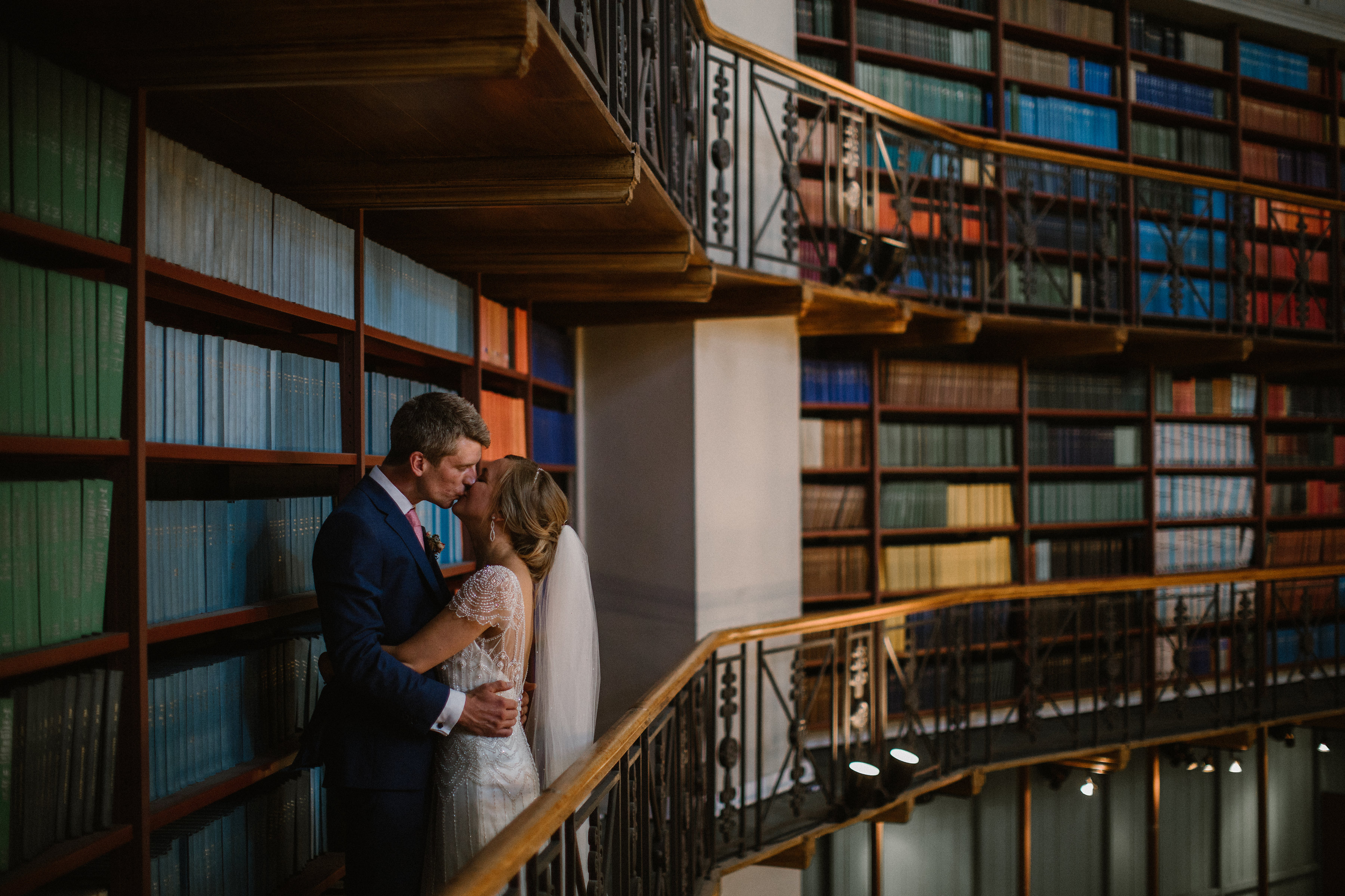 Romantic couple in elegant library at Queen Mary Venues for intimate weddings and events.