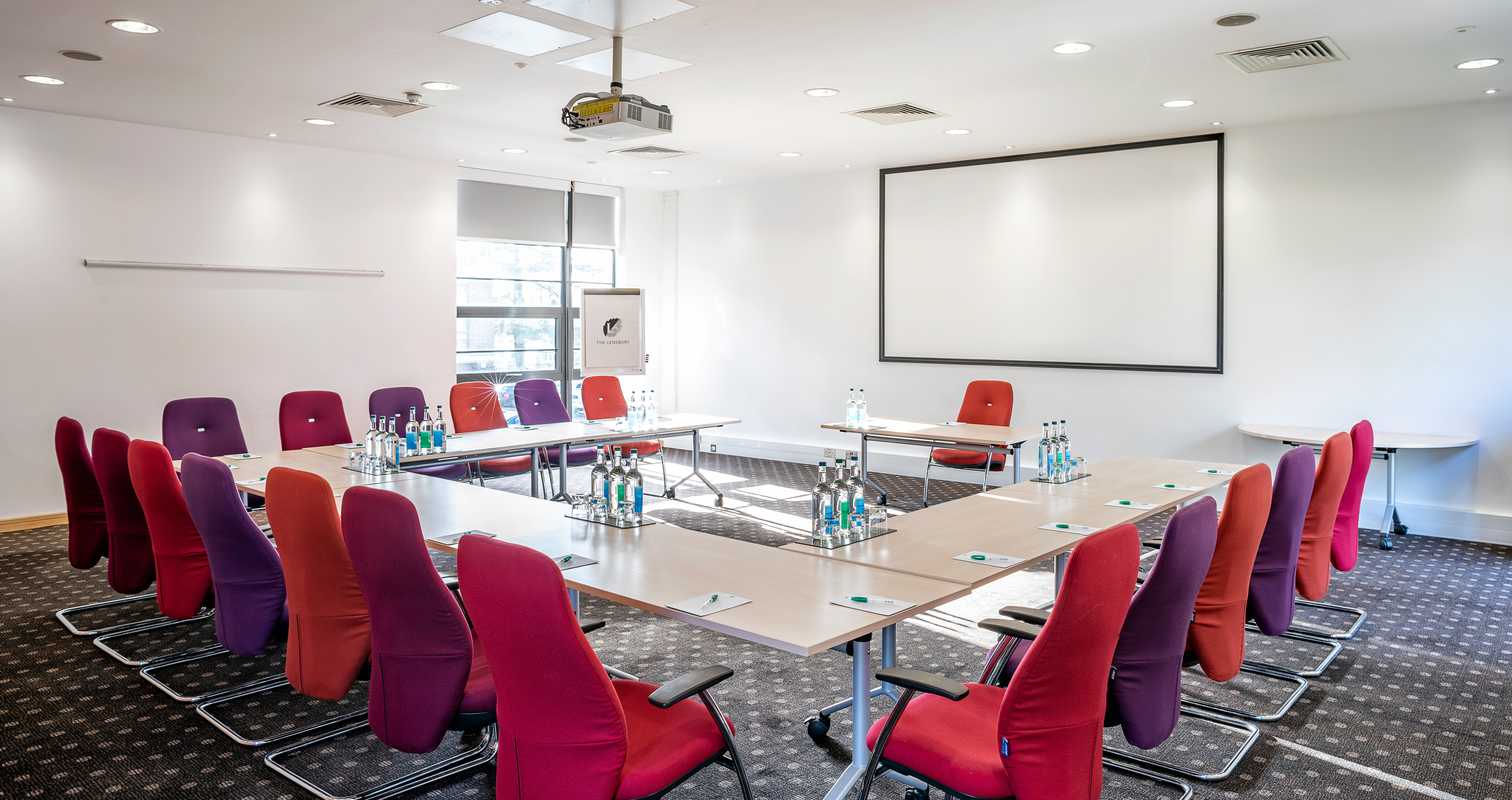 Meeting room with vibrant seating, ideal for collaborative workshops and presentations.