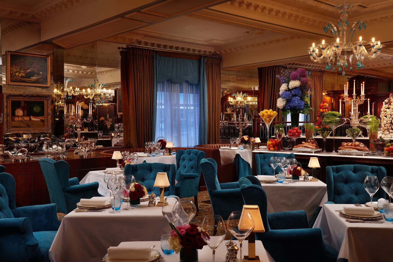Elegant dining space at The English Grill, plush blue chairs for upscale events.