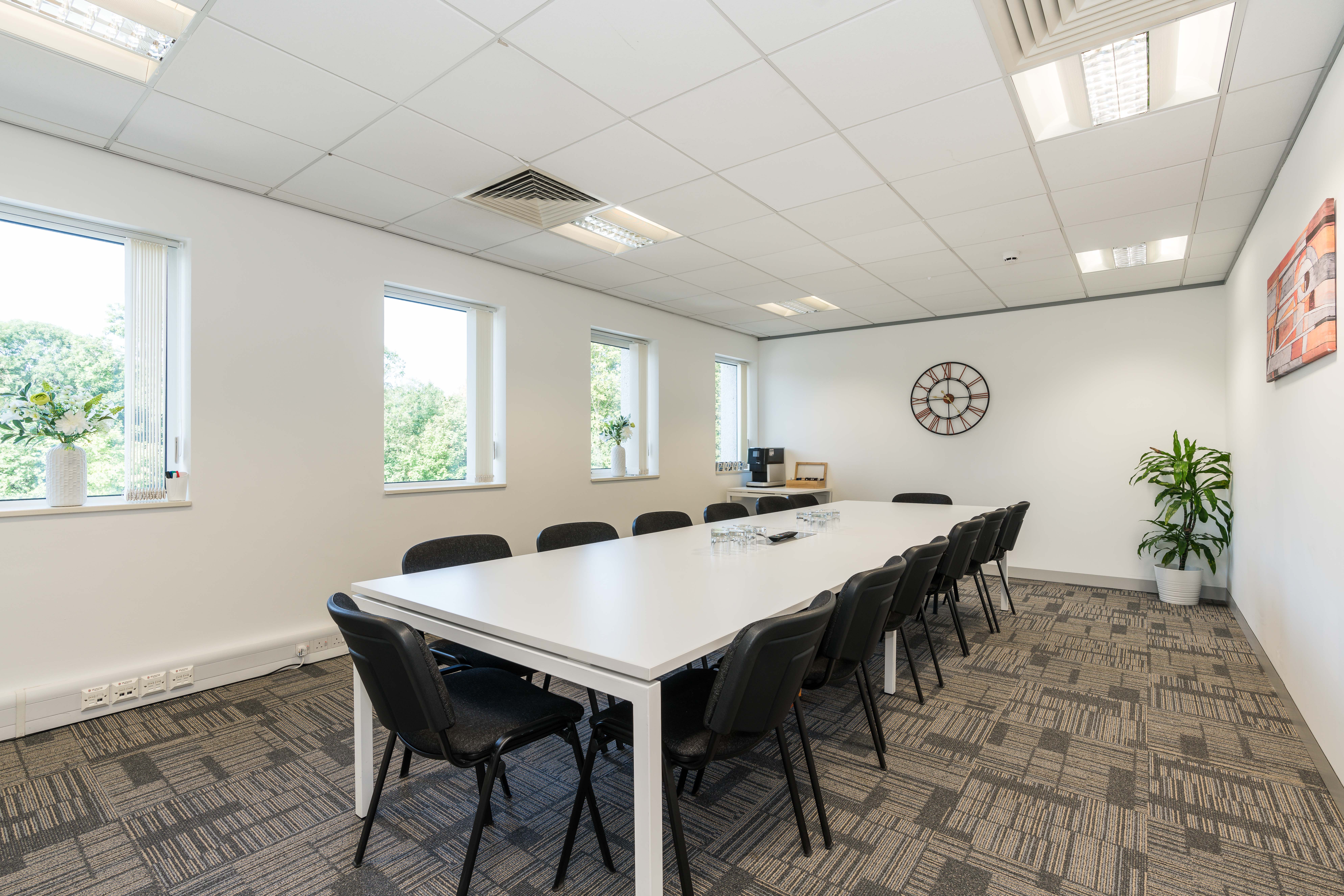 Orange Suite at UBC Warrington: bright meeting room with long table, ideal for events.