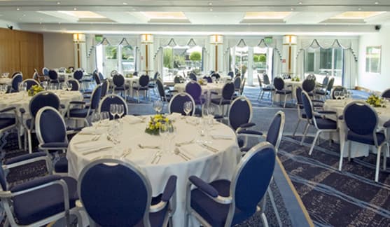 Longley Suite at Arora Hotel: elegant event space with round tables for corporate meetings.