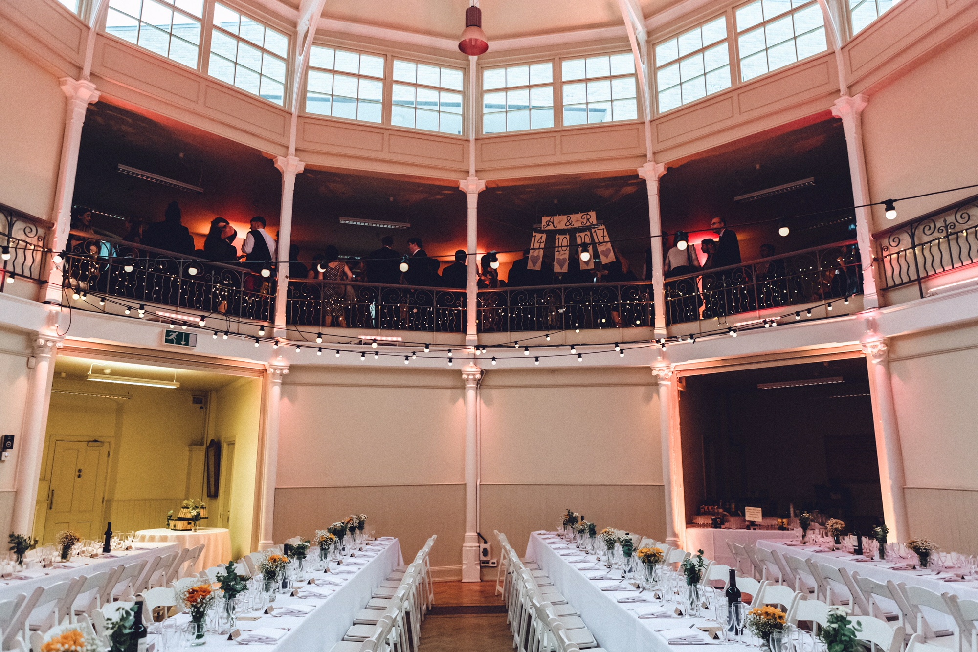Elegant lecture hall with long tables, perfect for weddings and formal events.