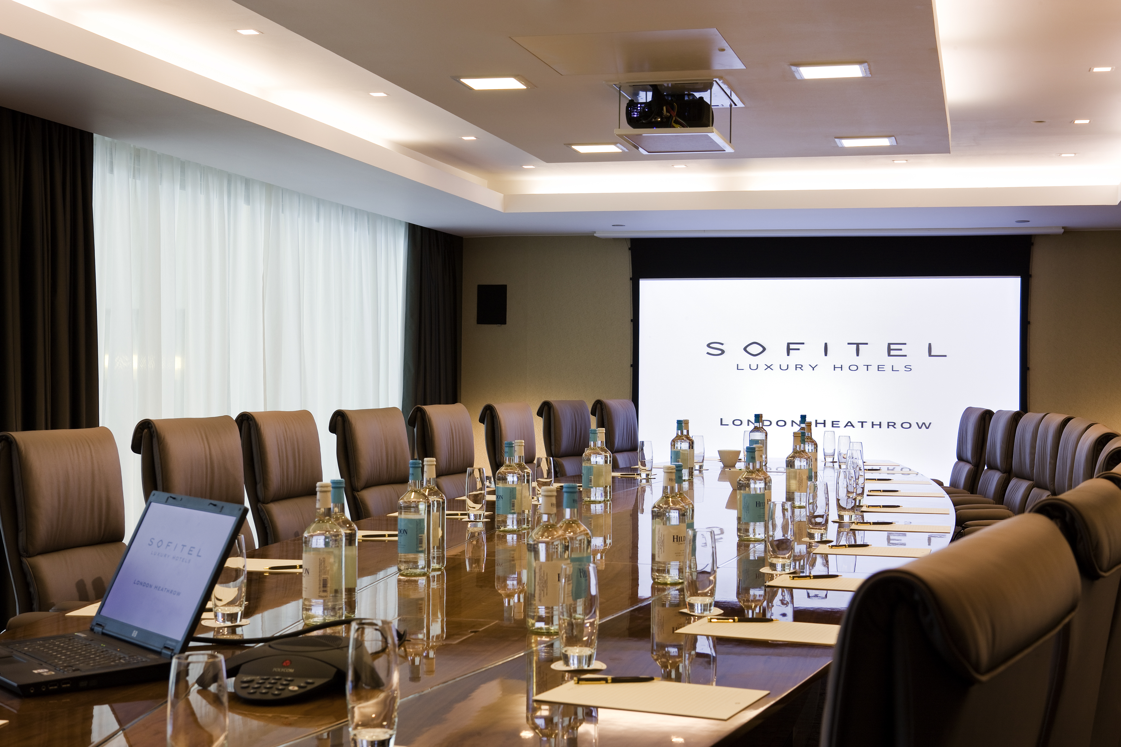 Opera Boardroom at Sofitel London Heathrow, polished table, ideal for corporate meetings.
