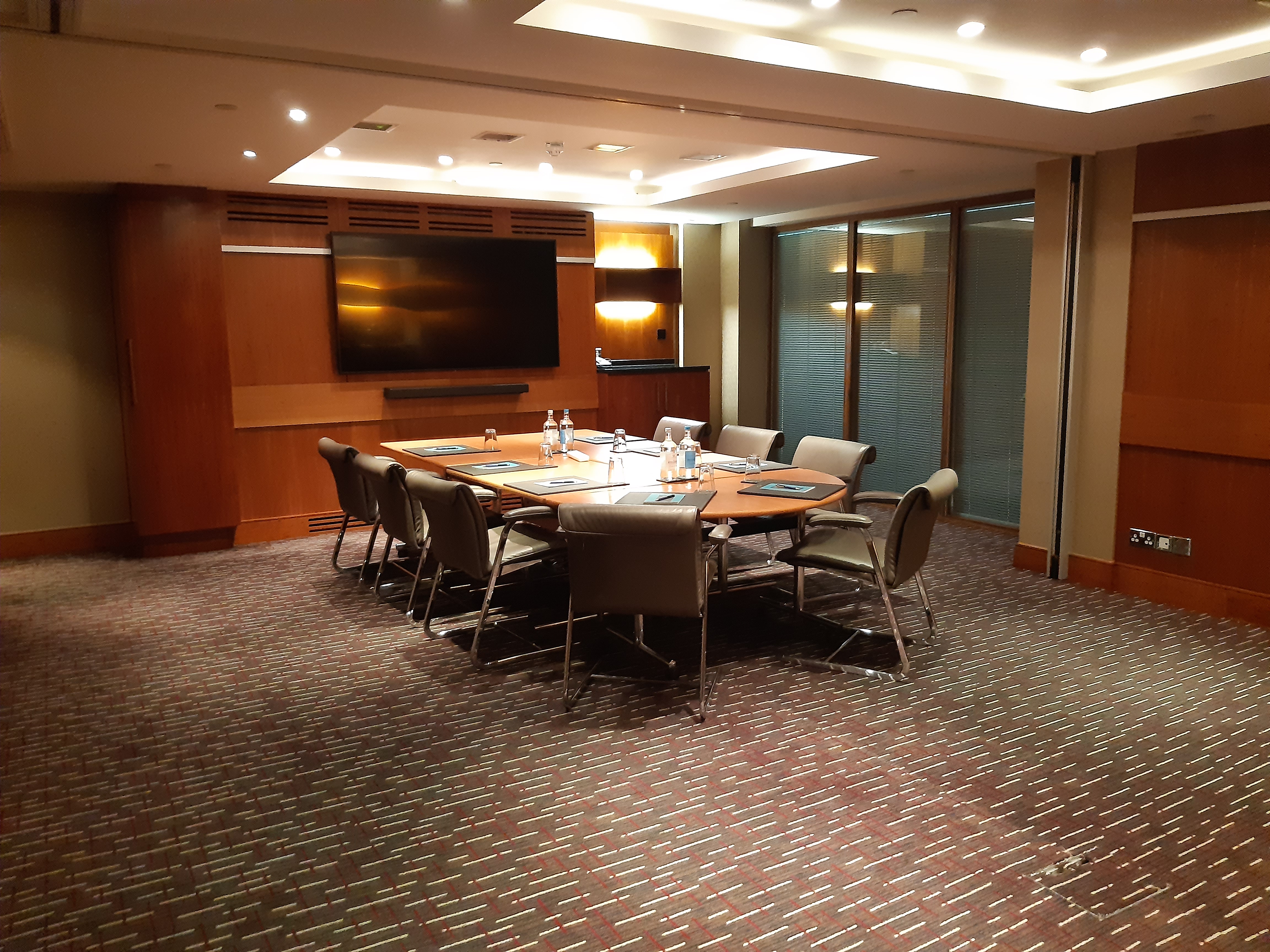 Meeting room at Sofitel London Heathrow with central table, ideal for conferences and presentations.