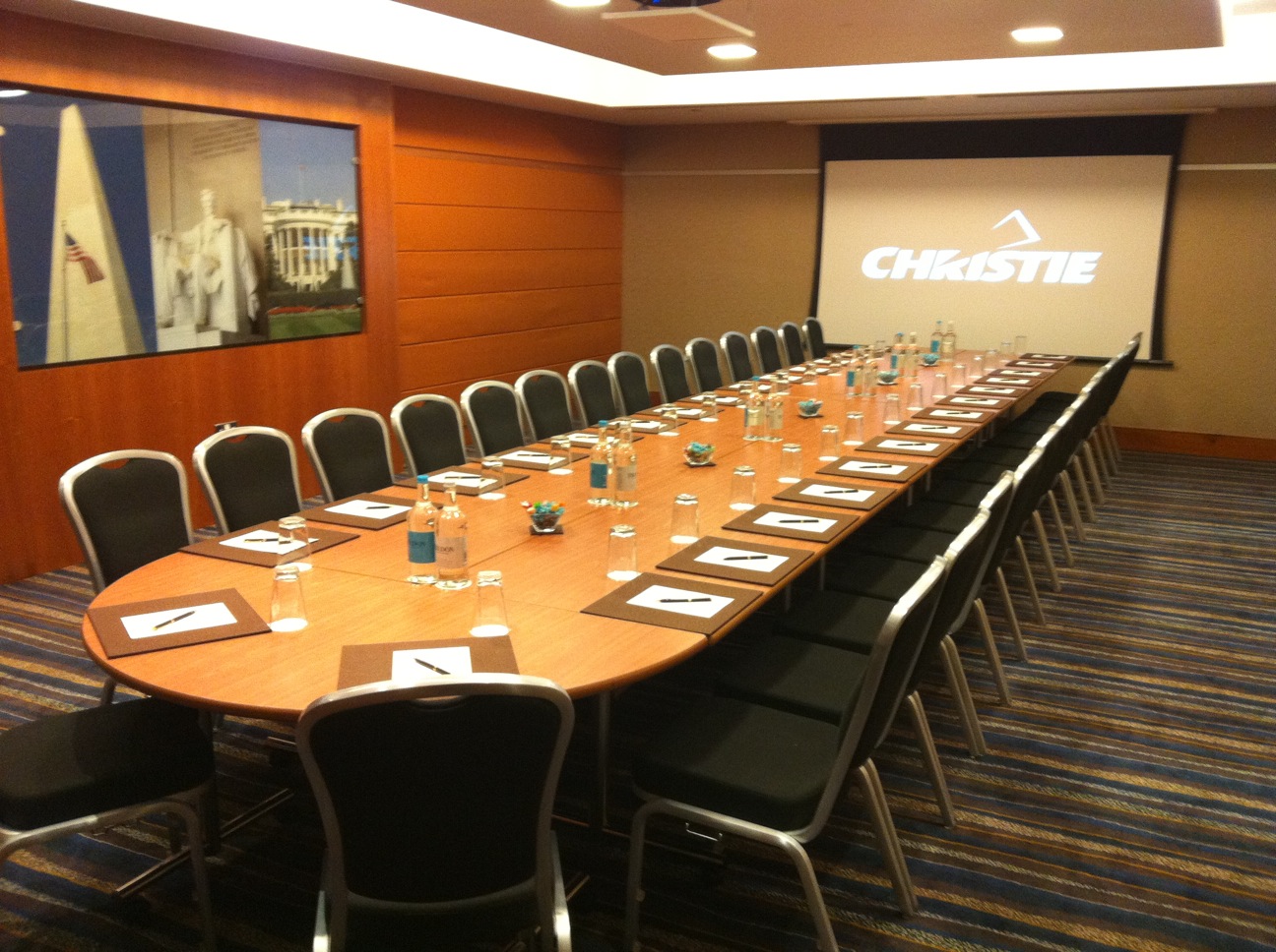 Corporate meeting room at Sofitel London Heathrow with oval table and branding.