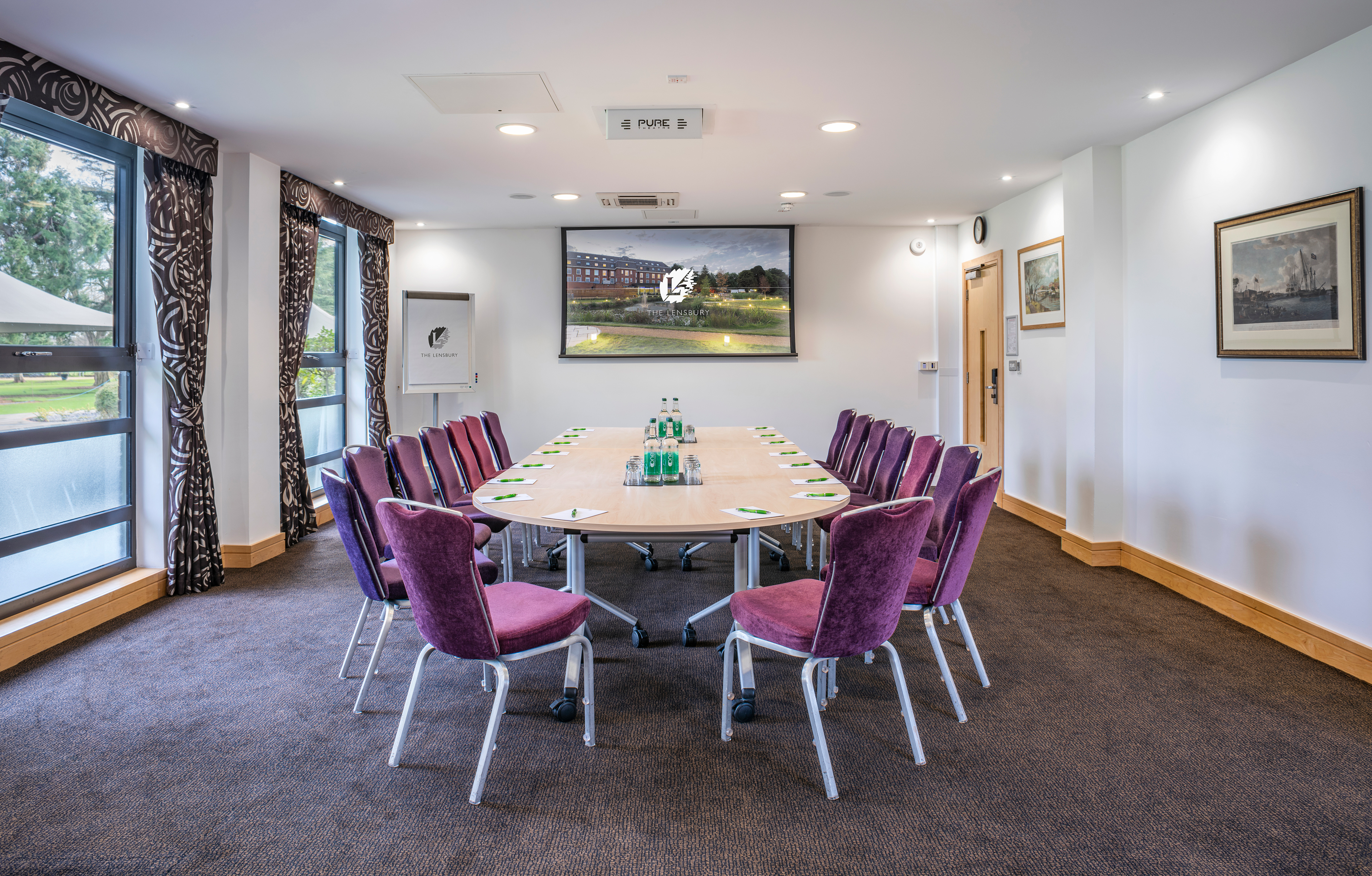 Mortimer Room at The Lensbury: oval table, natural light, ideal for meetings and events.