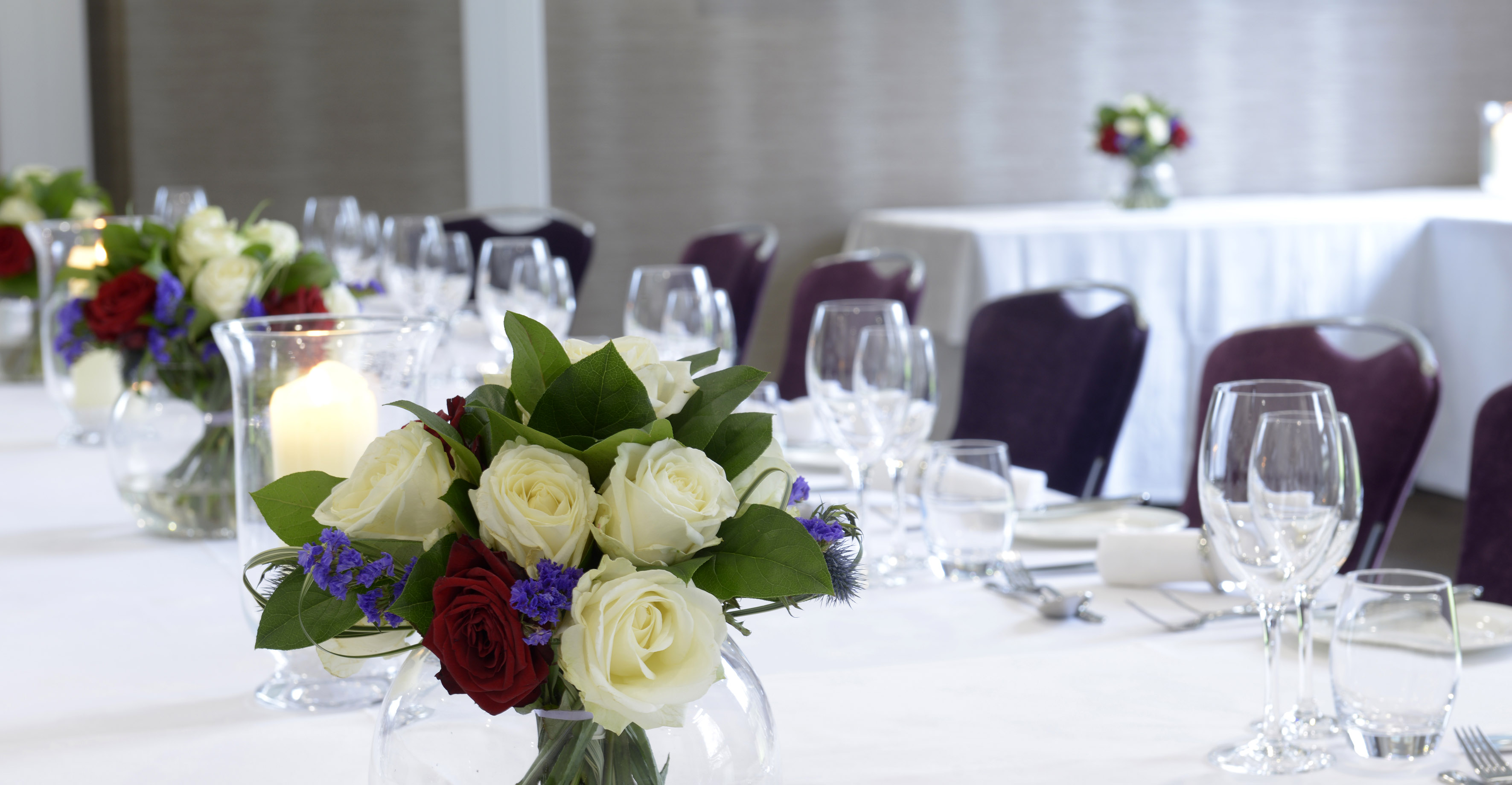 Elegant dining table with roses in Mortimer Room, ideal for weddings and corporate events.