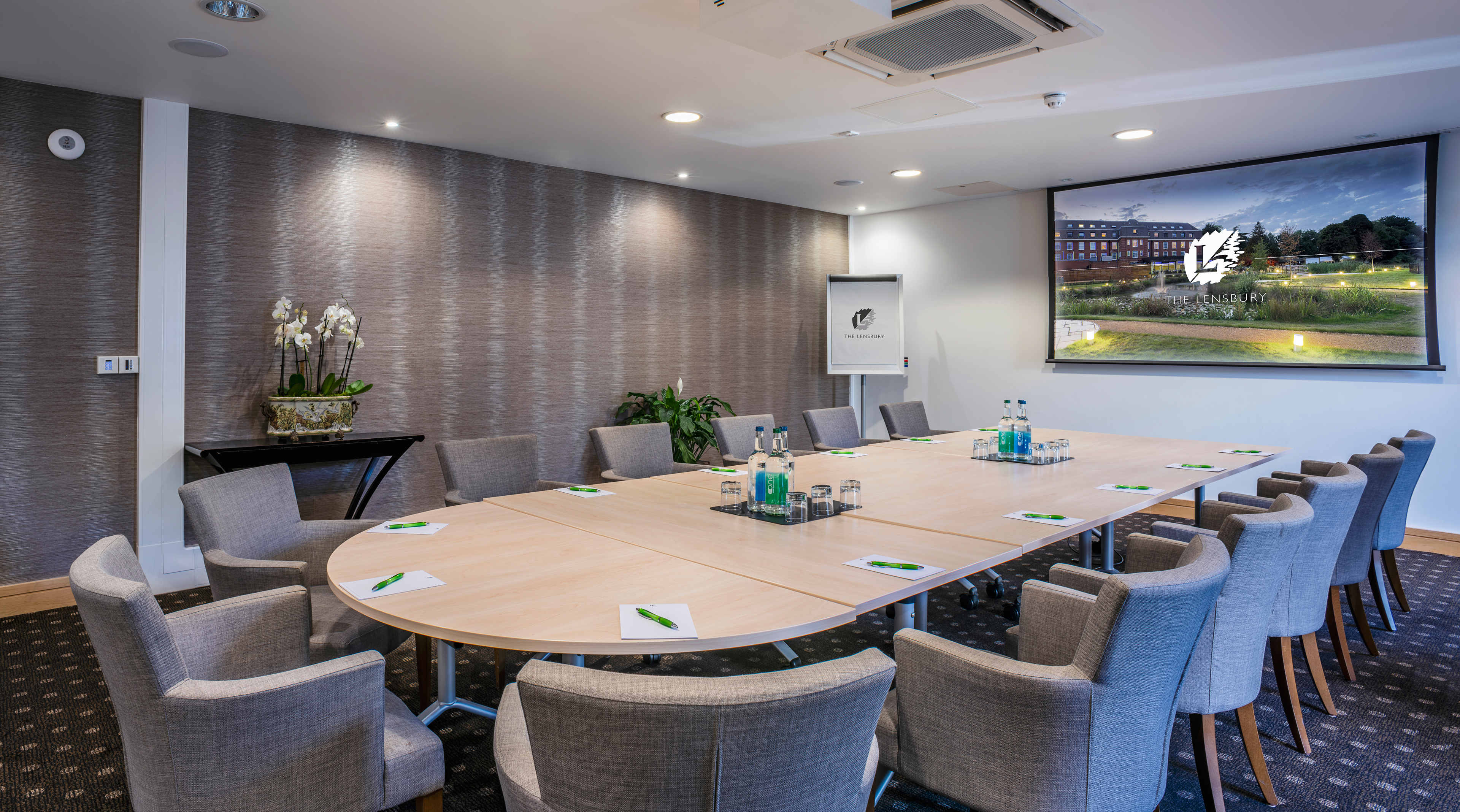 Lloyd Room at The Lensbury: elegant meeting space with oval table for corporate workshops.