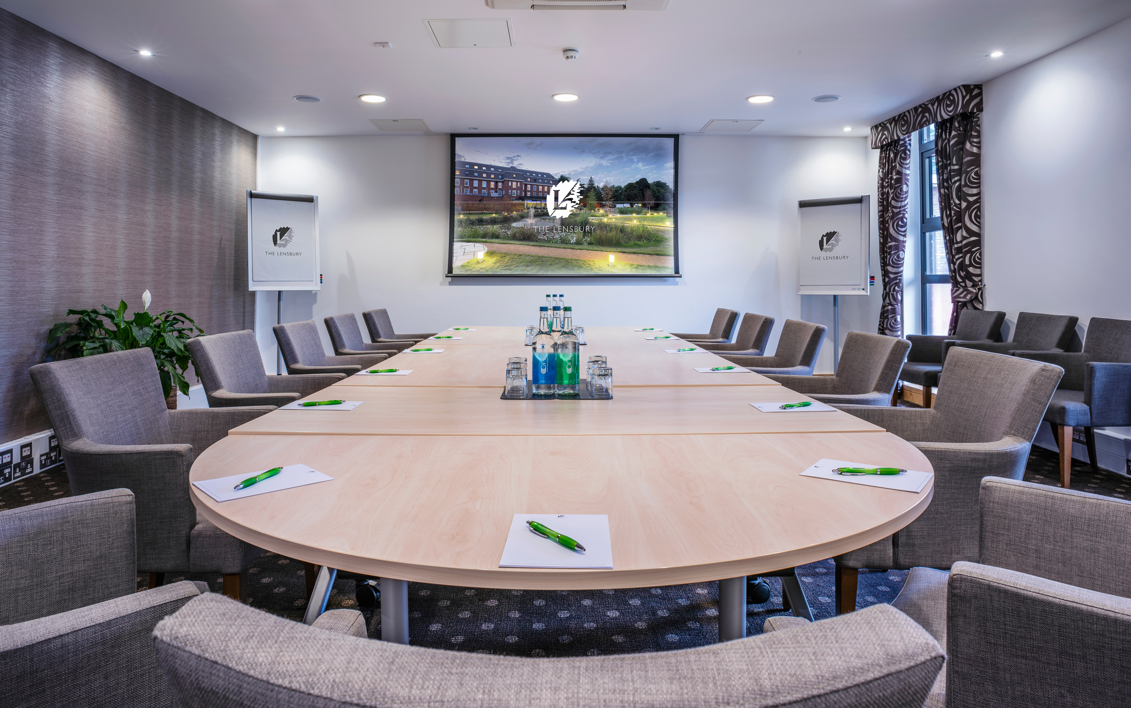Lloyd Room at The Lensbury: modern meeting space with oval table for professional gatherings.