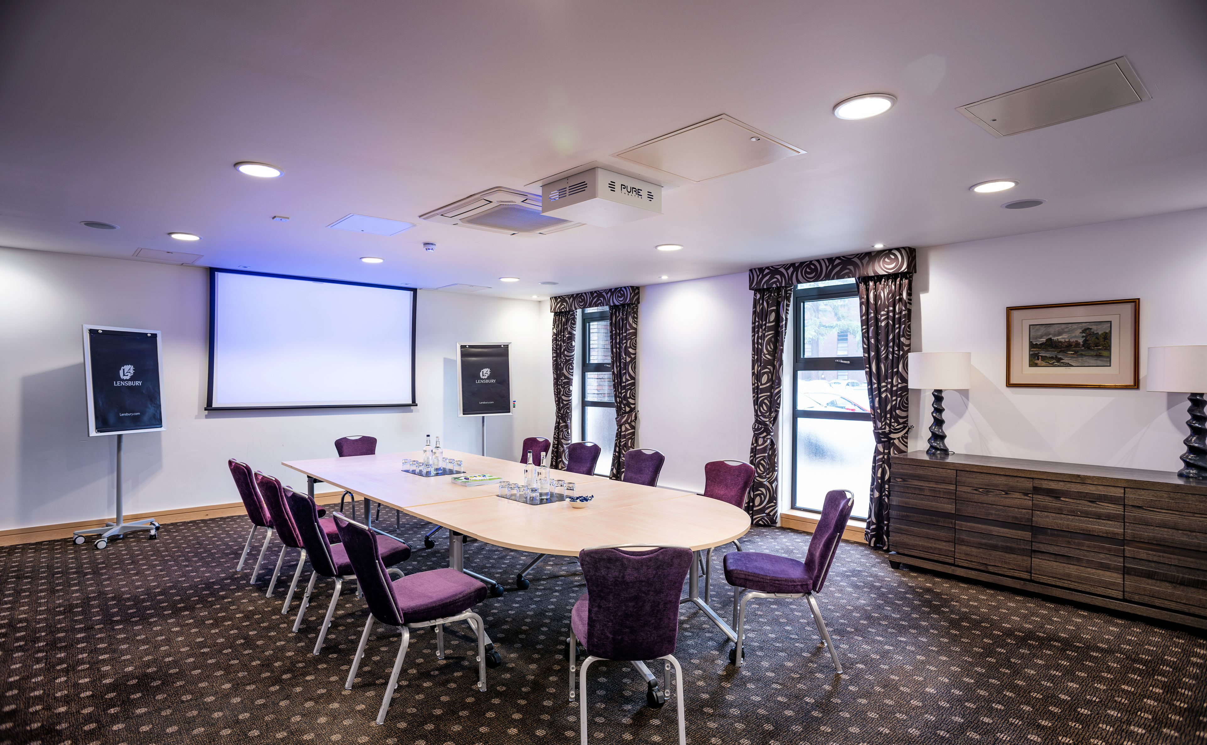 Lloyd Room at The Lensbury: oval table meeting space for workshops and strategy sessions.