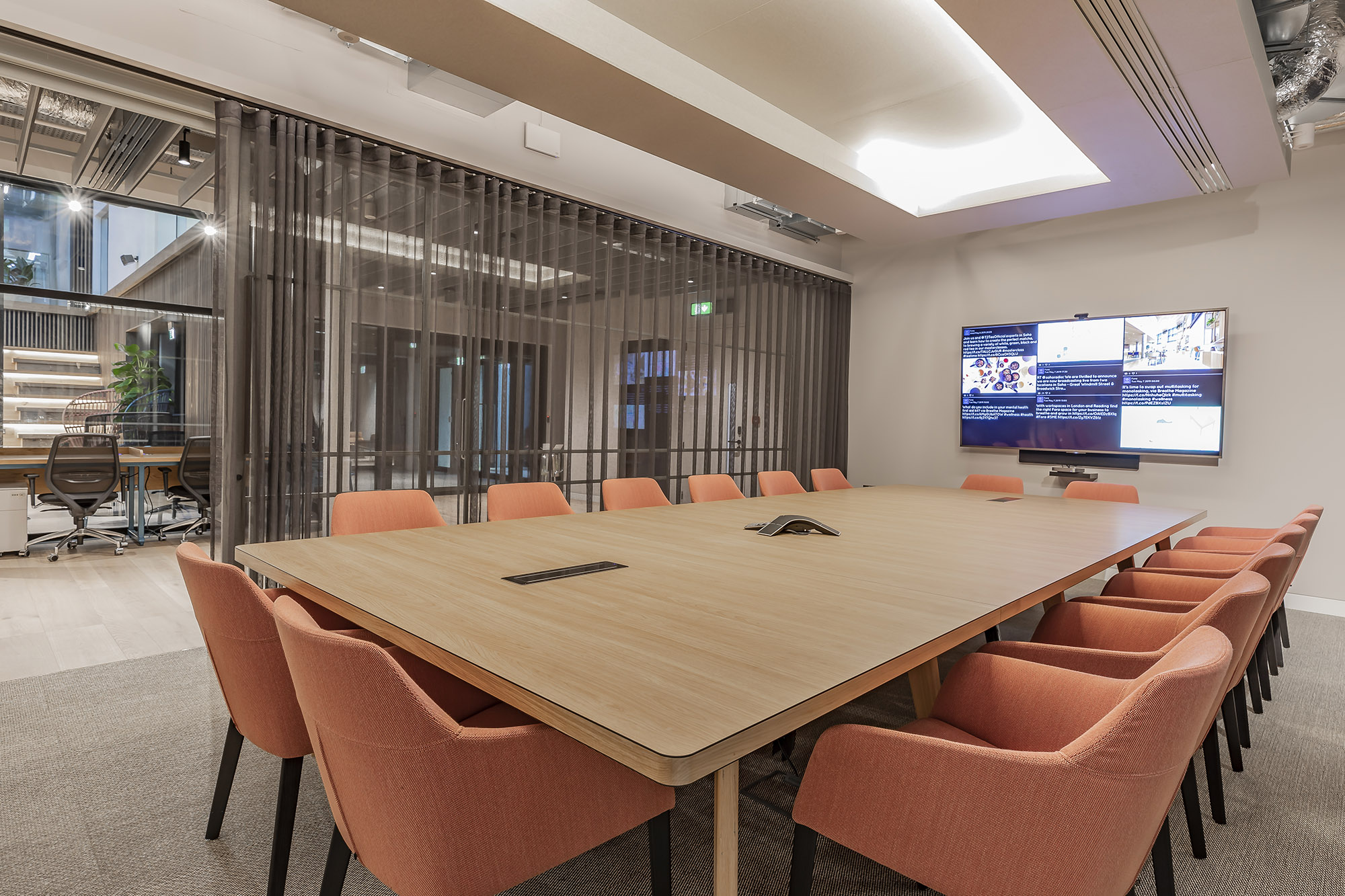 Modern conference room with large screen, ideal for corporate events and meetings.