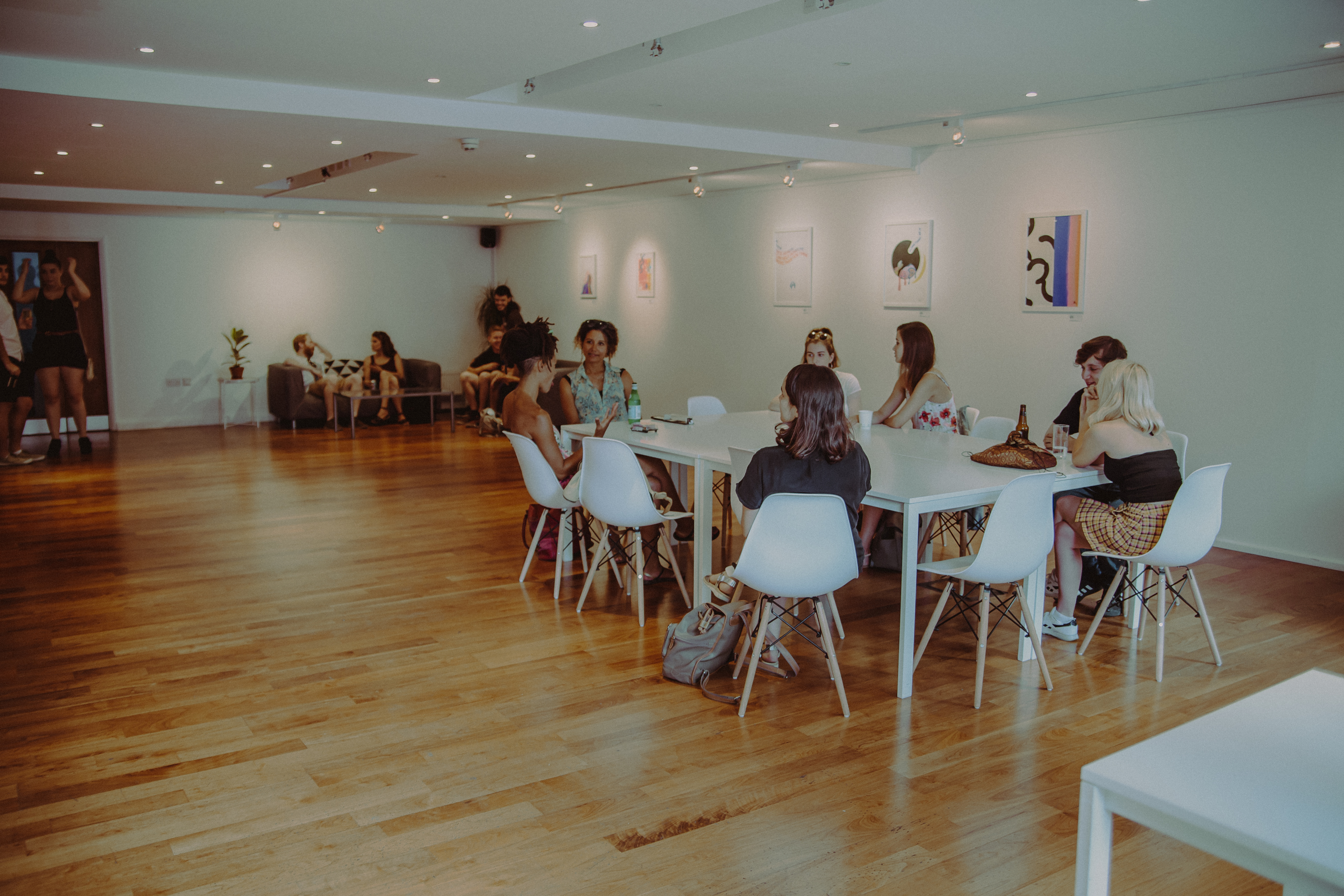 Modern reception area with attendees discussing, perfect for workshops and networking events.