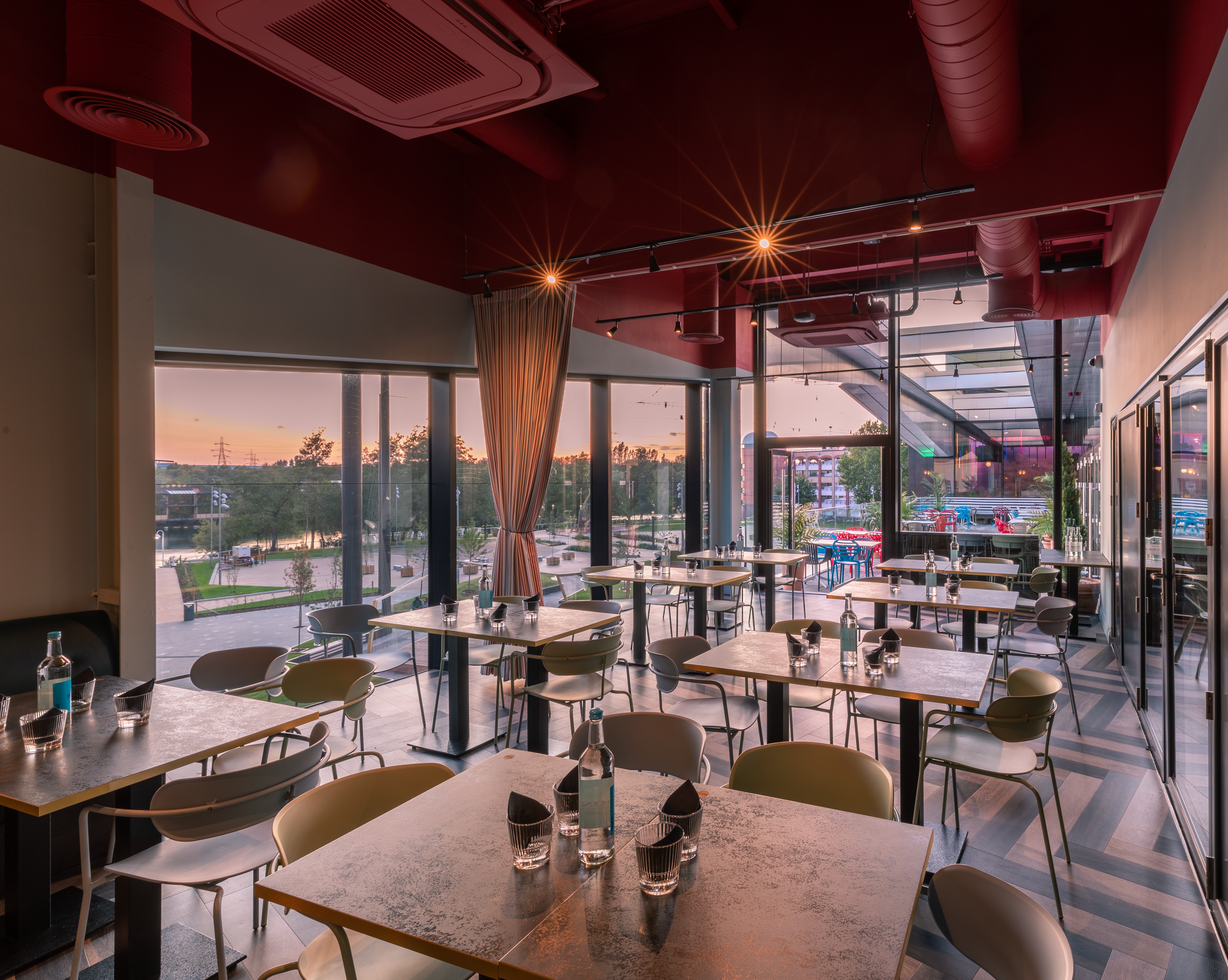 Sapphire Private Room at Puttshack: modern event space with natural light for gatherings.