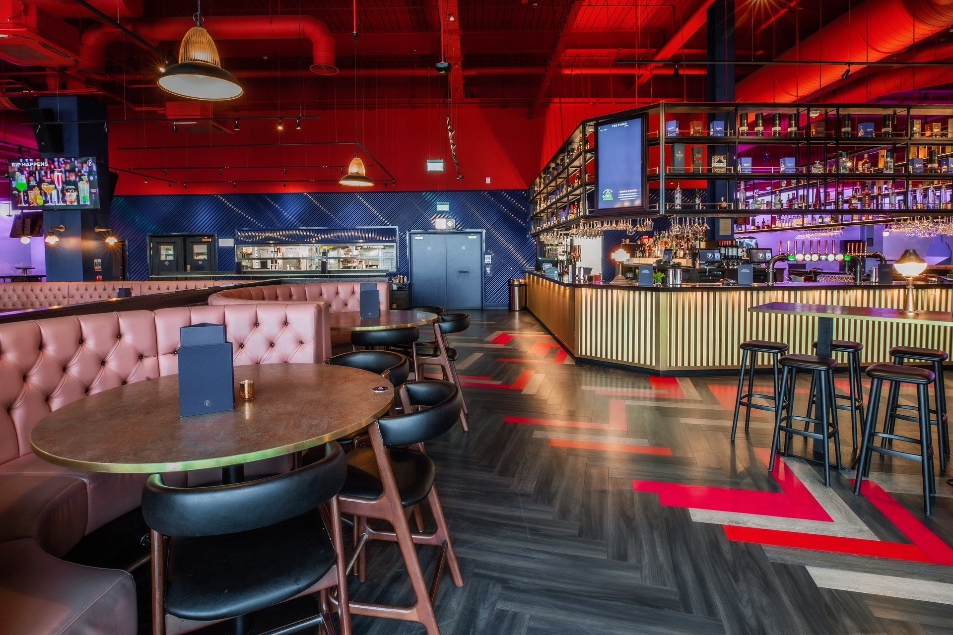 Christmas event at Puttshack Lakeside with vibrant decor and stylish bar seating.