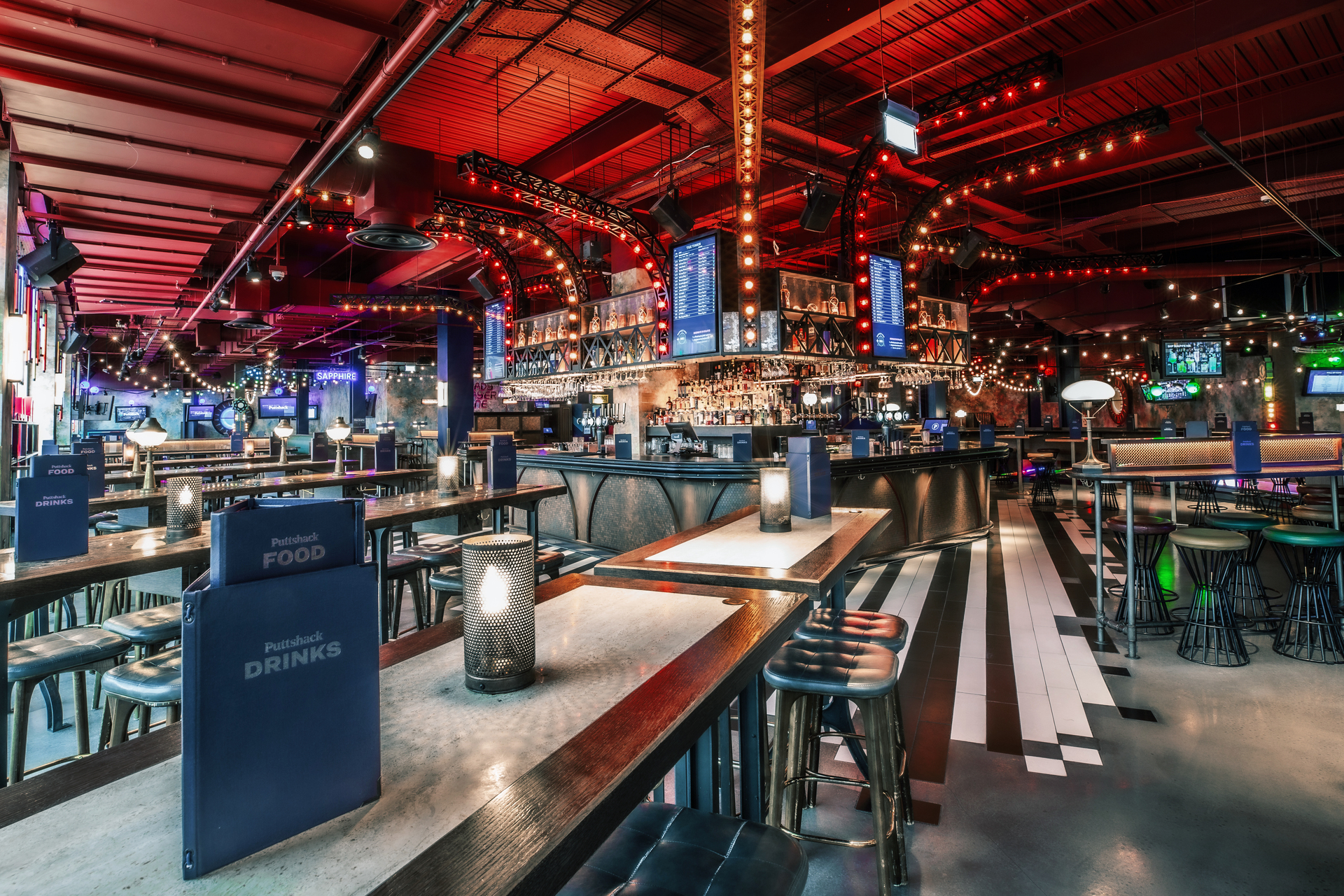 Christmas event venue with stylish seating and ambient lighting at Puttshack White City.