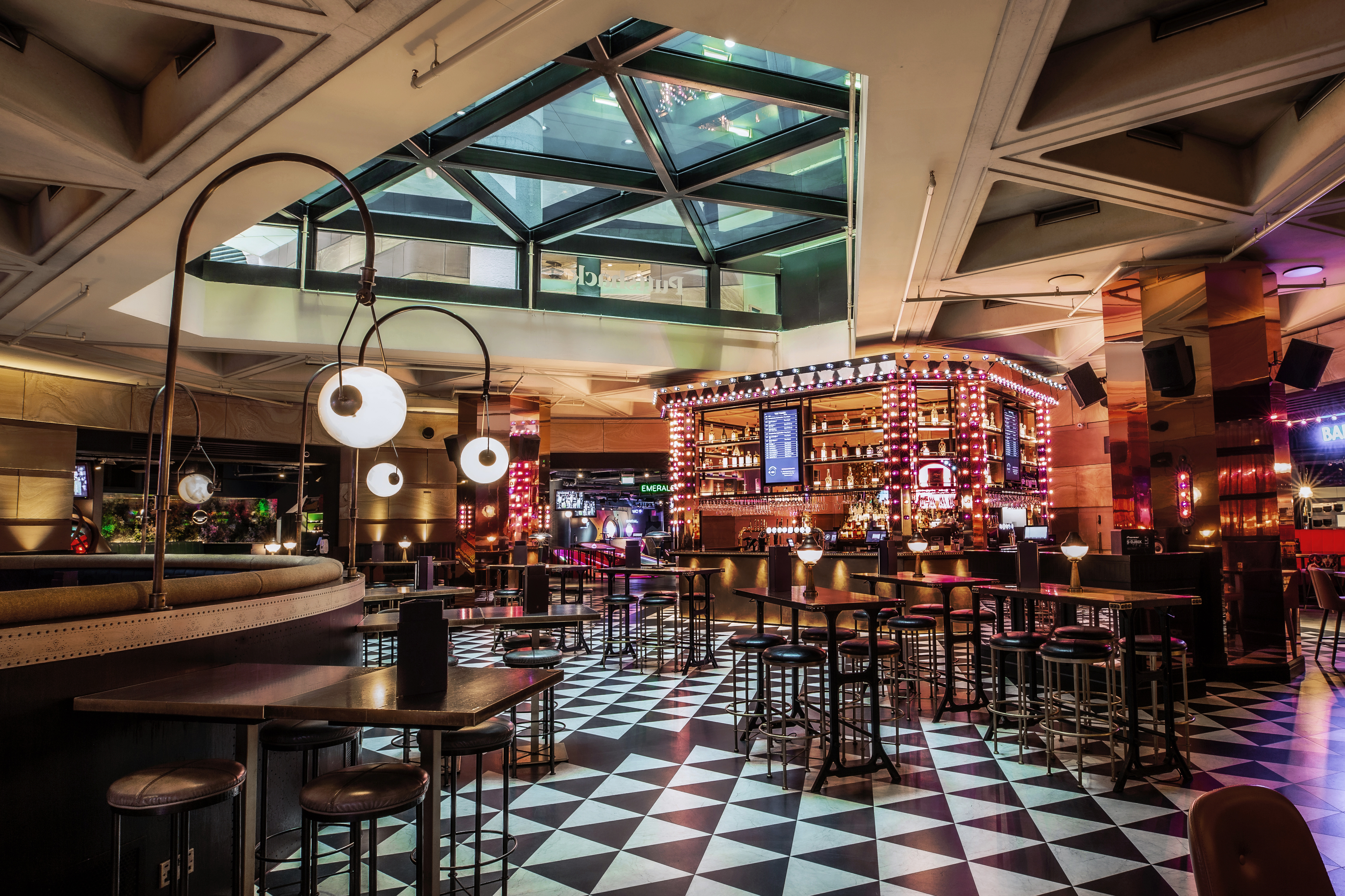 Christmas party at Puttshack with modern bar and stylish seating in vibrant event space.