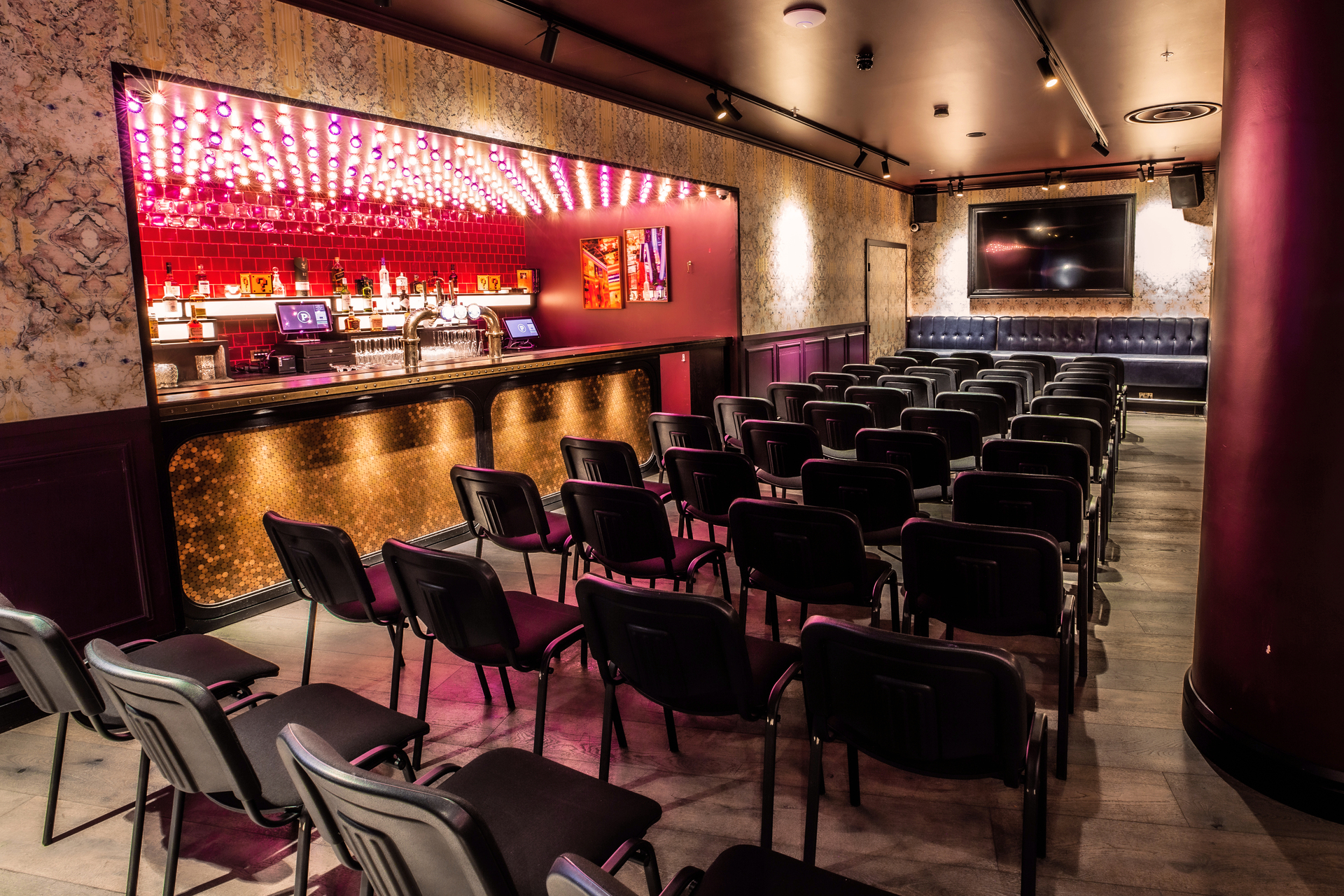 Christmas party at Puttshack Bank with sleek bar and vibrant lighting for networking events.