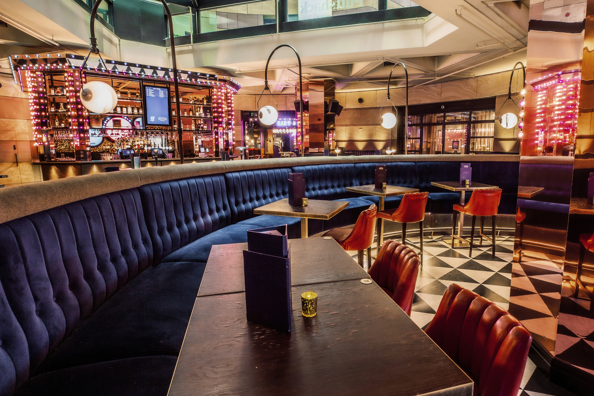 Christmas party at Puttshack Bank with modern decor and vibrant lighting for social gatherings.