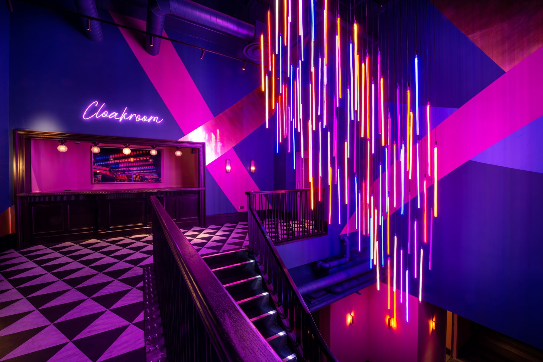 Christmas party at Puttshack Bank with vibrant lighting and modern decor.