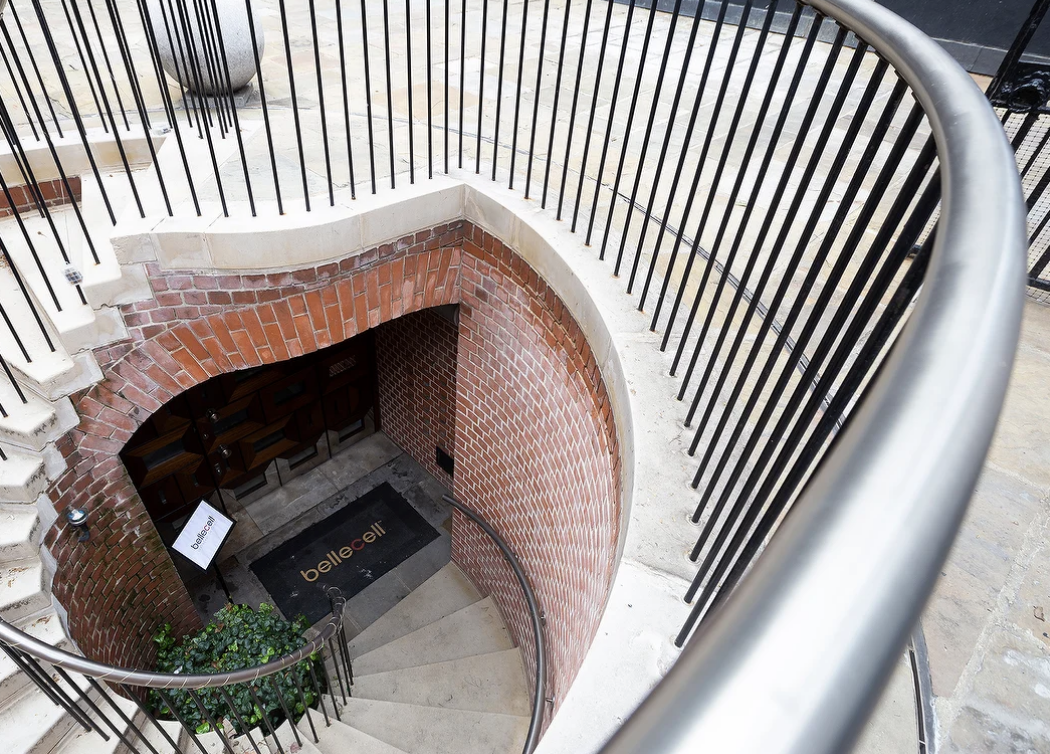 Stylish spiral staircase in BelleCell Clinic's consultation rooms for events.