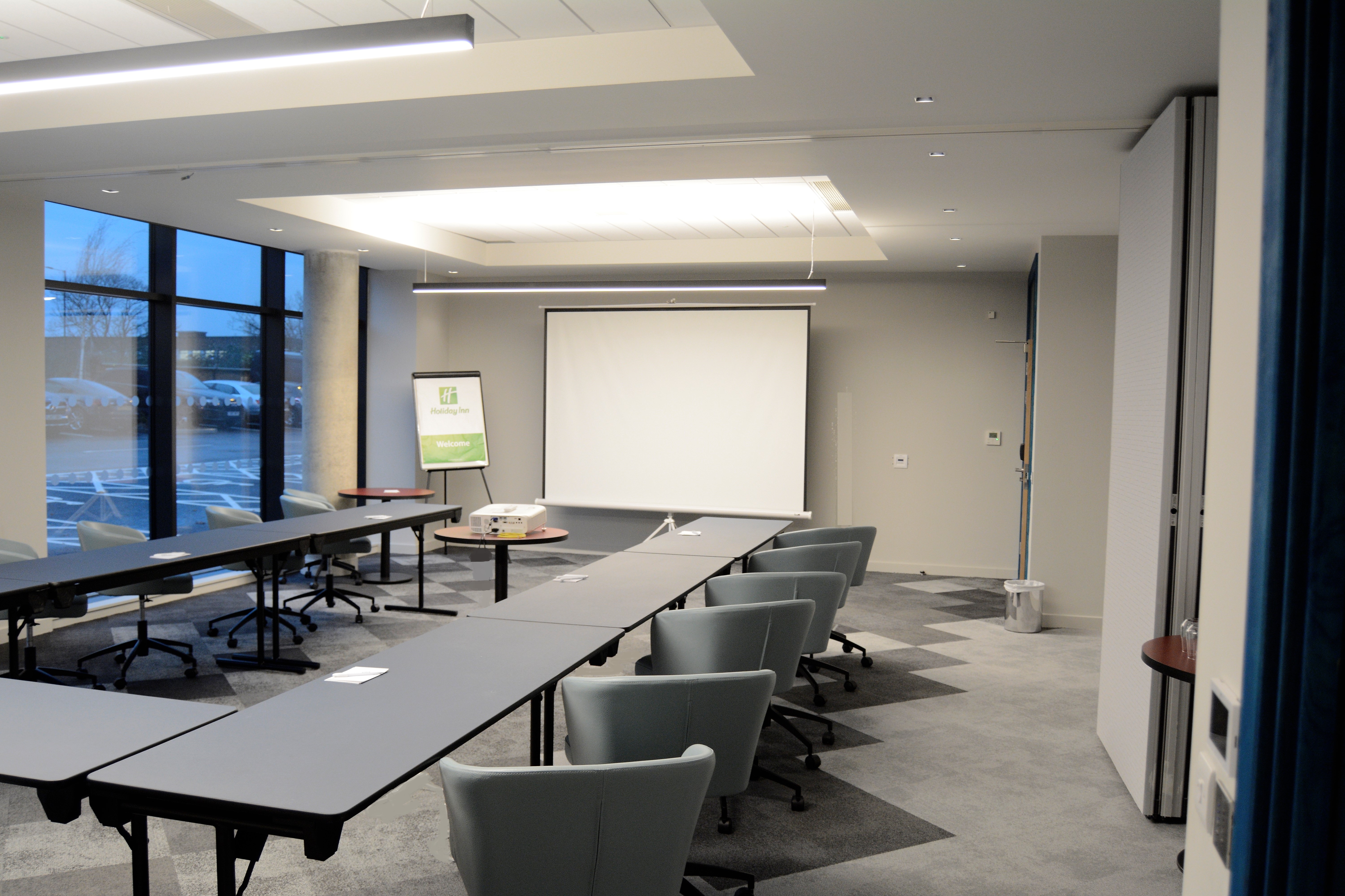 Modern meeting room at Holiday Inn Heathrow, ideal for workshops and presentations.