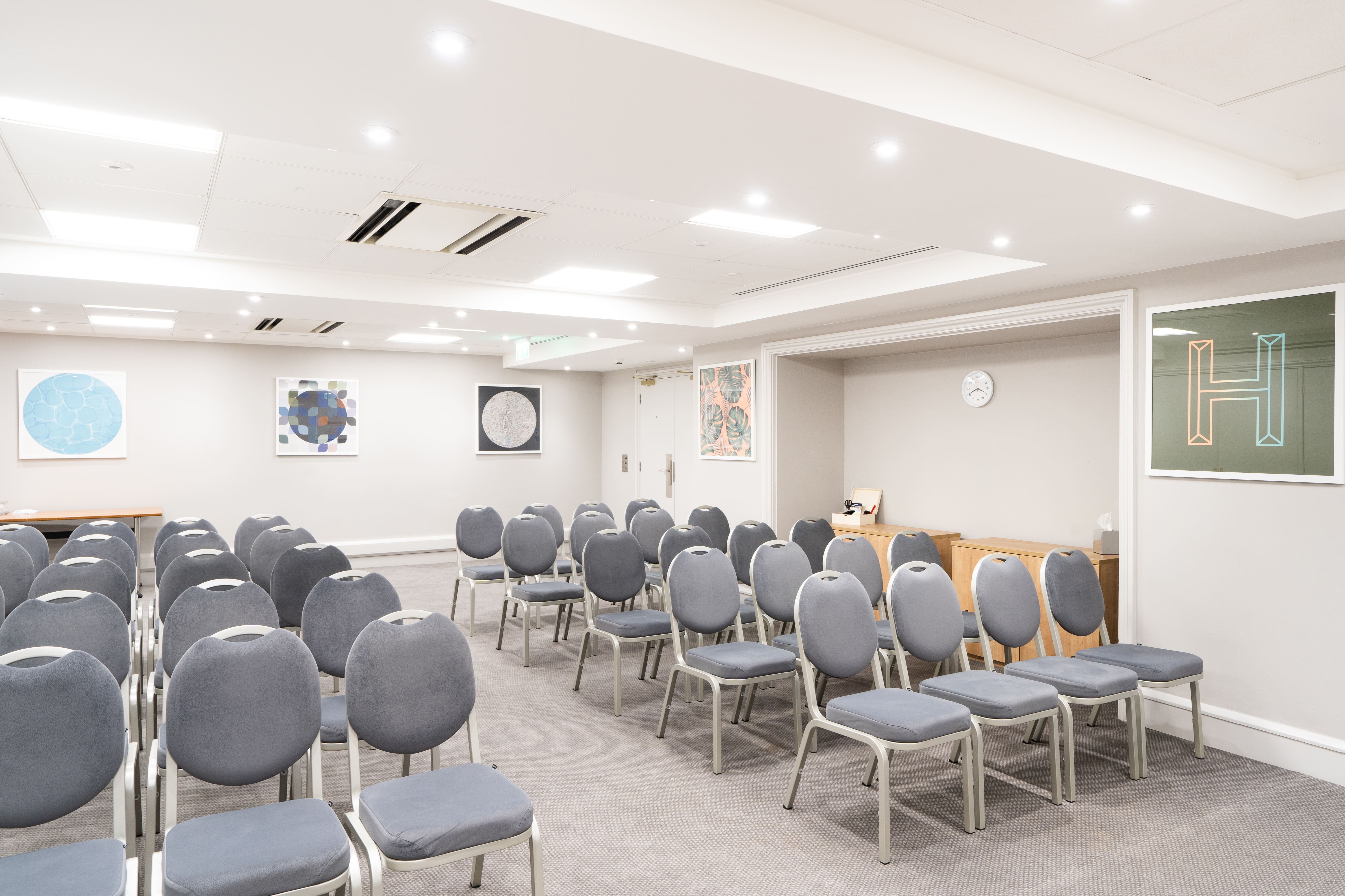 Langley Suite meeting room with gray chairs, ideal for presentations and workshops.