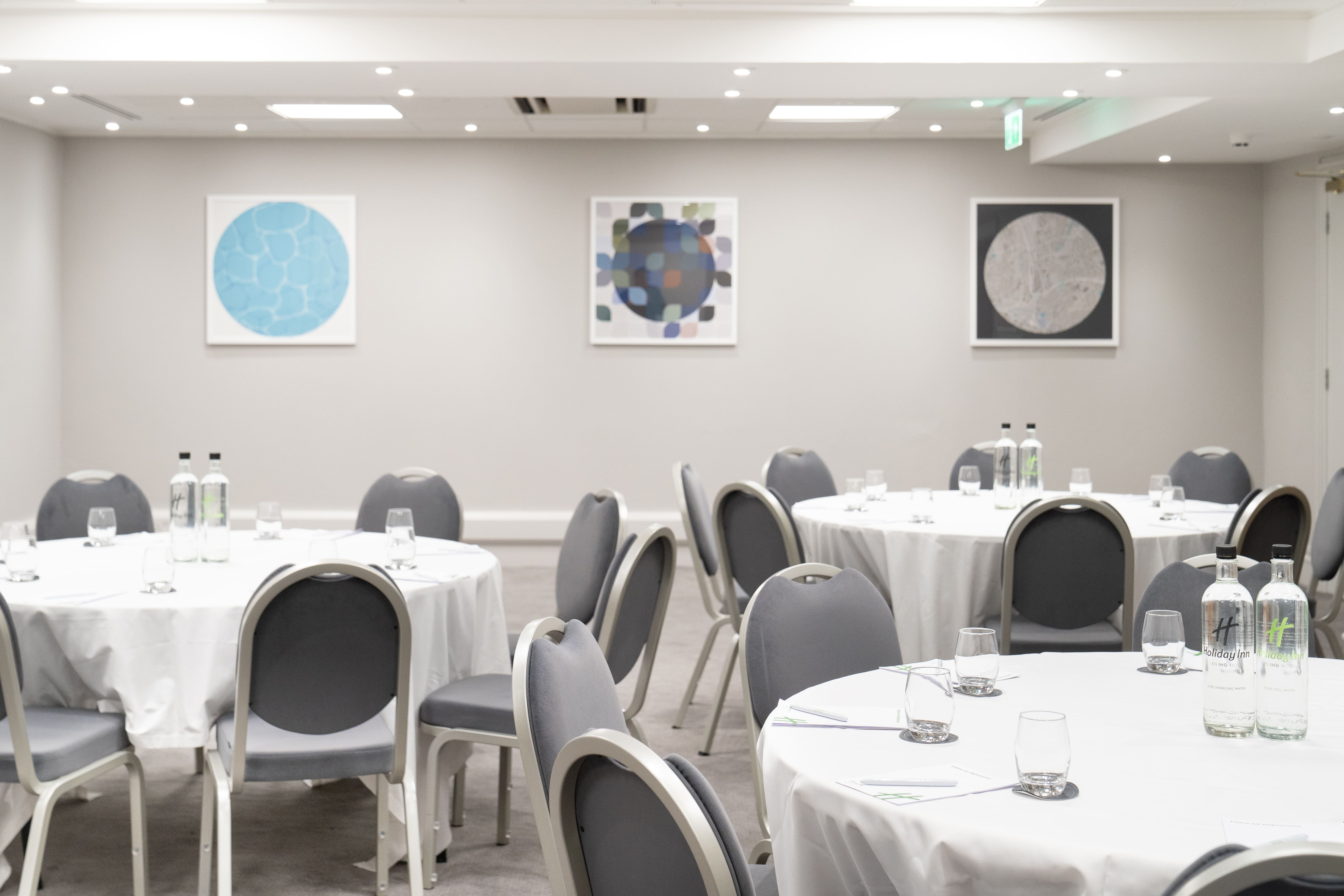 Langley Suite meeting room with round tables, ideal for conferences and workshops.