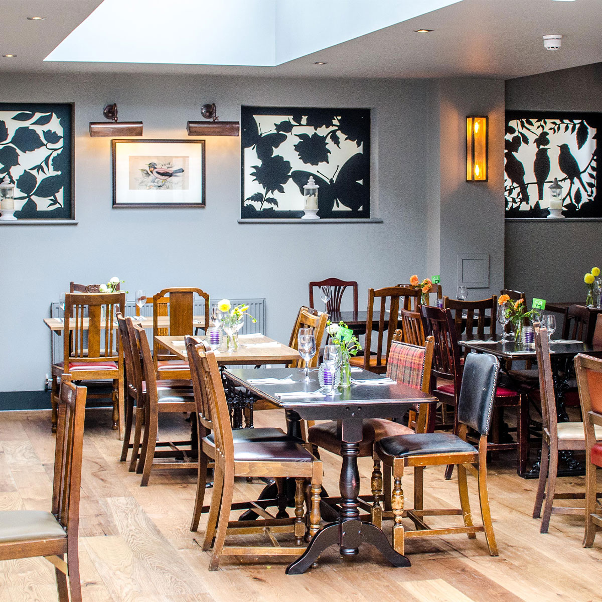 Event space at The Crown and Greyhound with wooden tables for meetings and gatherings.