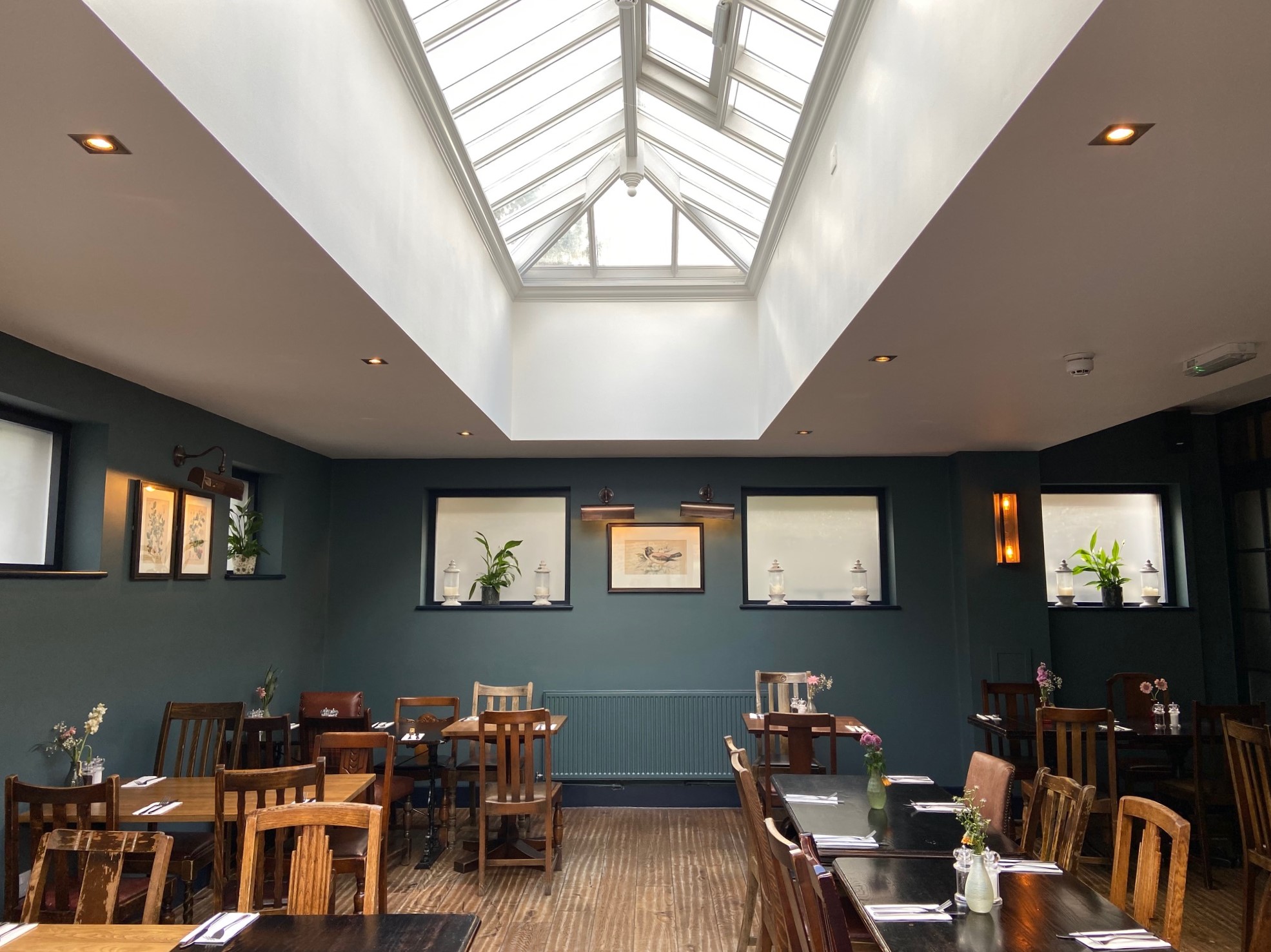 Modern dining space with skylight, perfect for intimate gatherings and workshops.