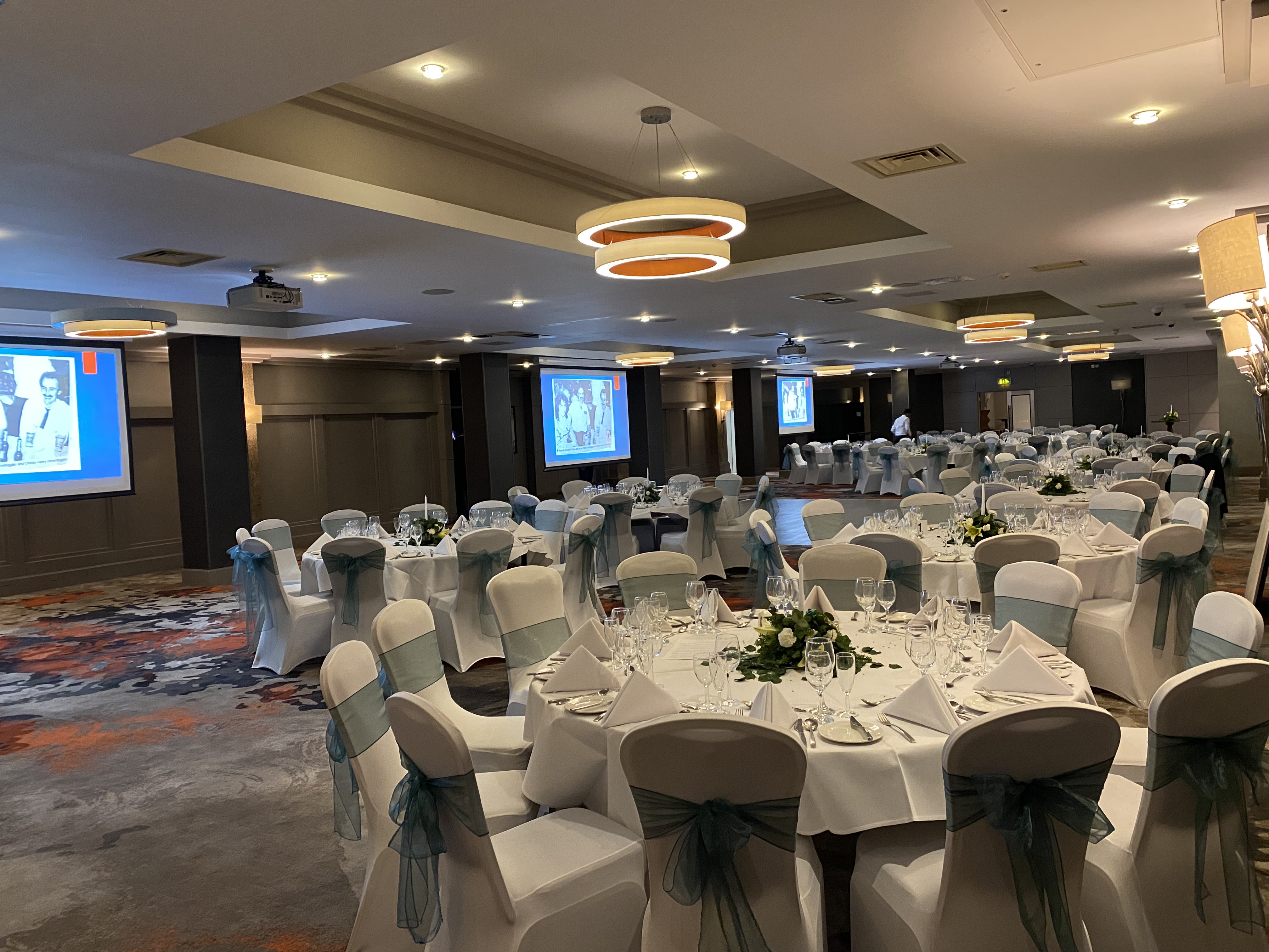 Ivy Suite banquet setup with round tables, ideal for corporate events and weddings.