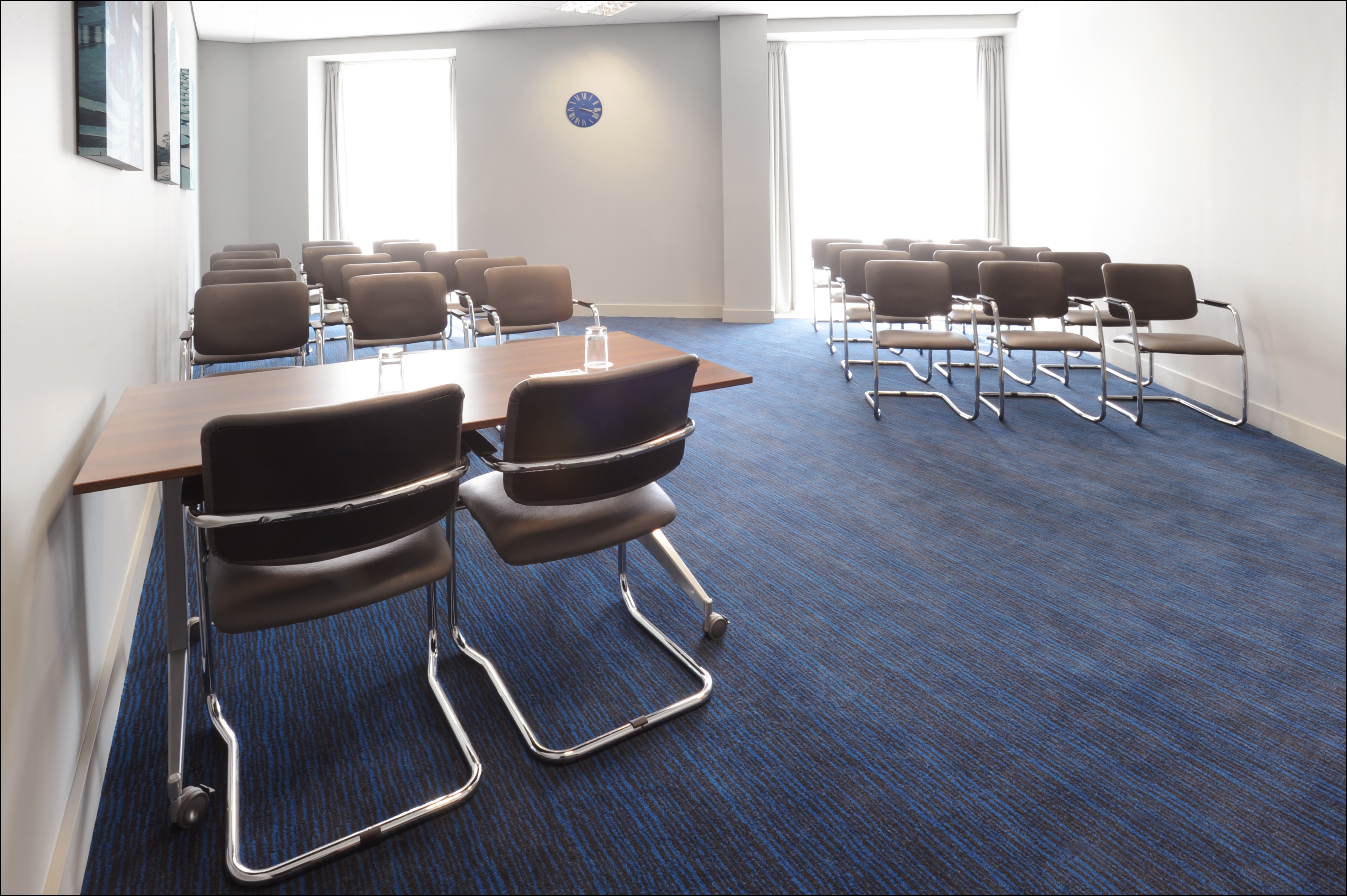 Modern meeting room with sleek chairs, ideal for workshops and team meetings.