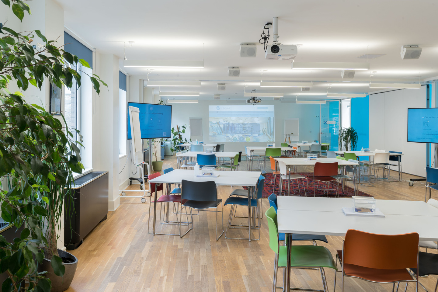 Modern meeting space at Wallacespace Spitalfields with natural light and greenery for events.