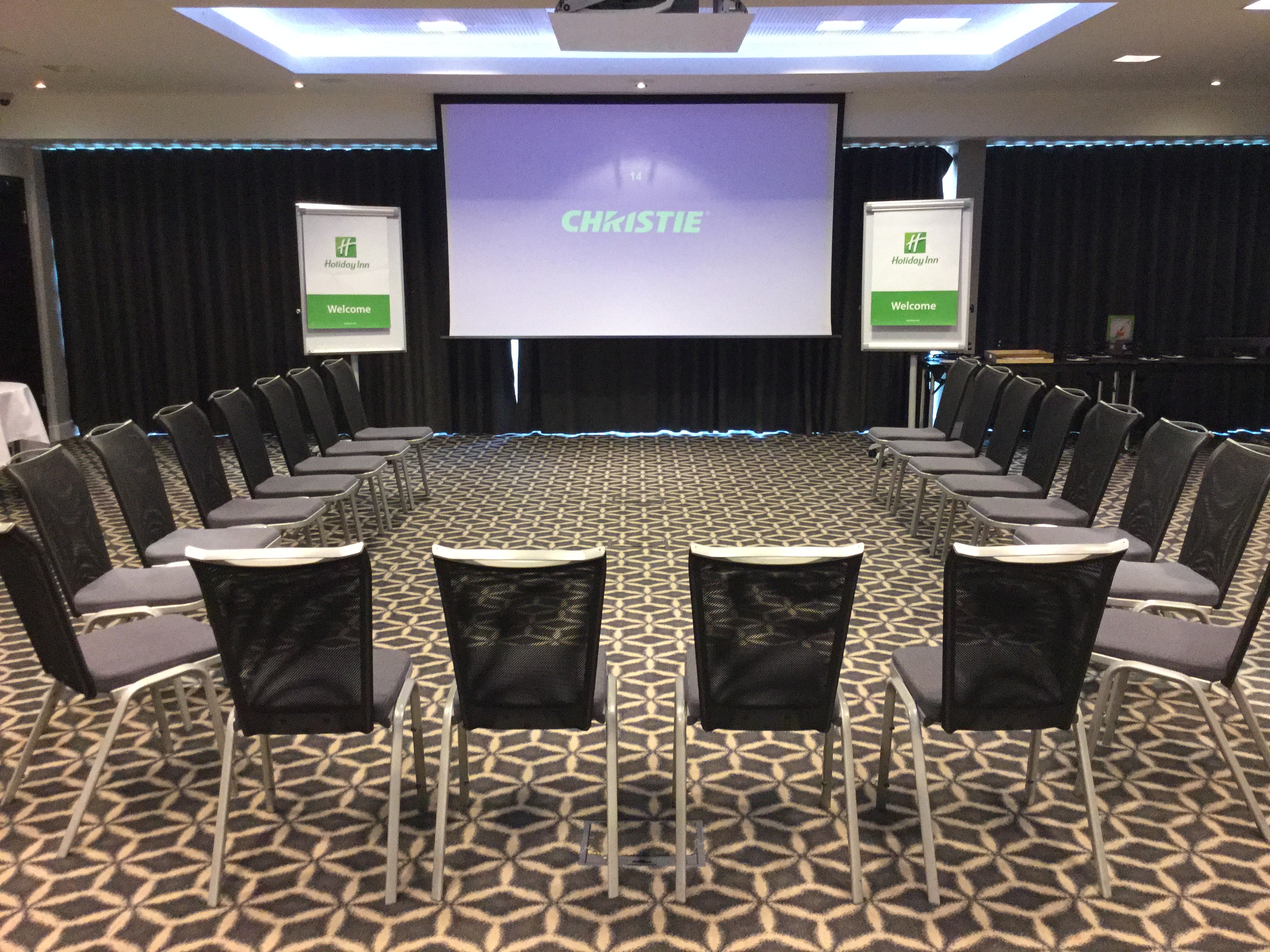 Laker Suite meeting space with circular seating and projector at Holiday Inn Southend.