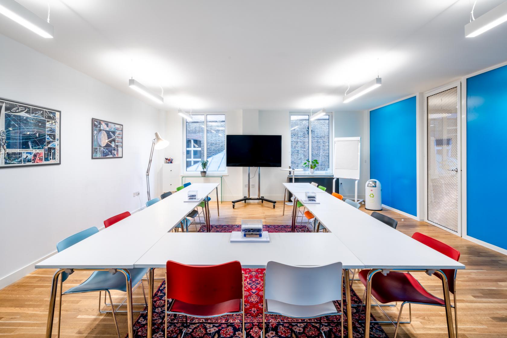 Modern meeting room at Vostok, vibrant colors, ideal for workshops and brainstorming.
