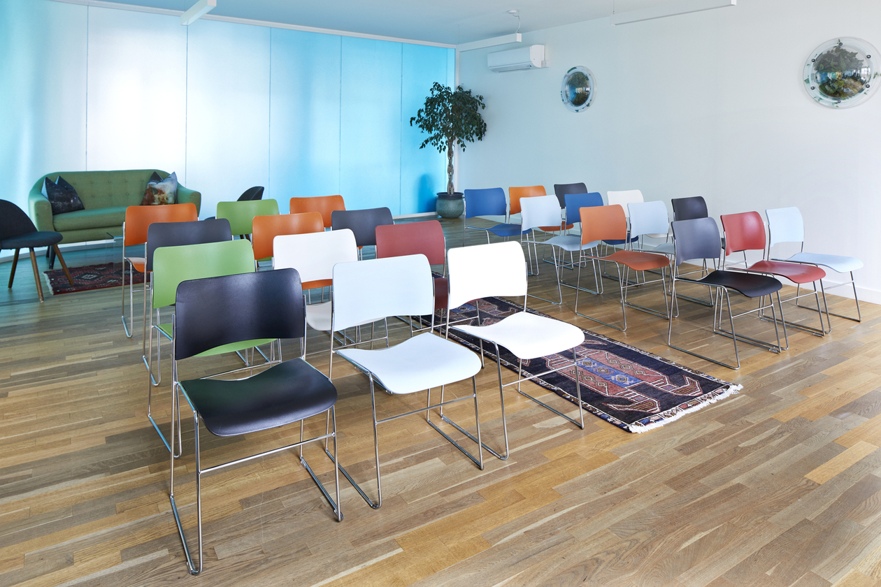 Valentina in vibrant workshop space with colorful chairs at Wallacespace Spitalfields.