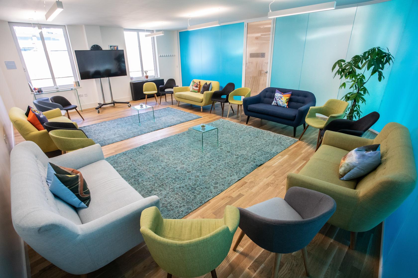 Valentina in a vibrant blue meeting space at Wallacespace Spitalfields for collaboration.