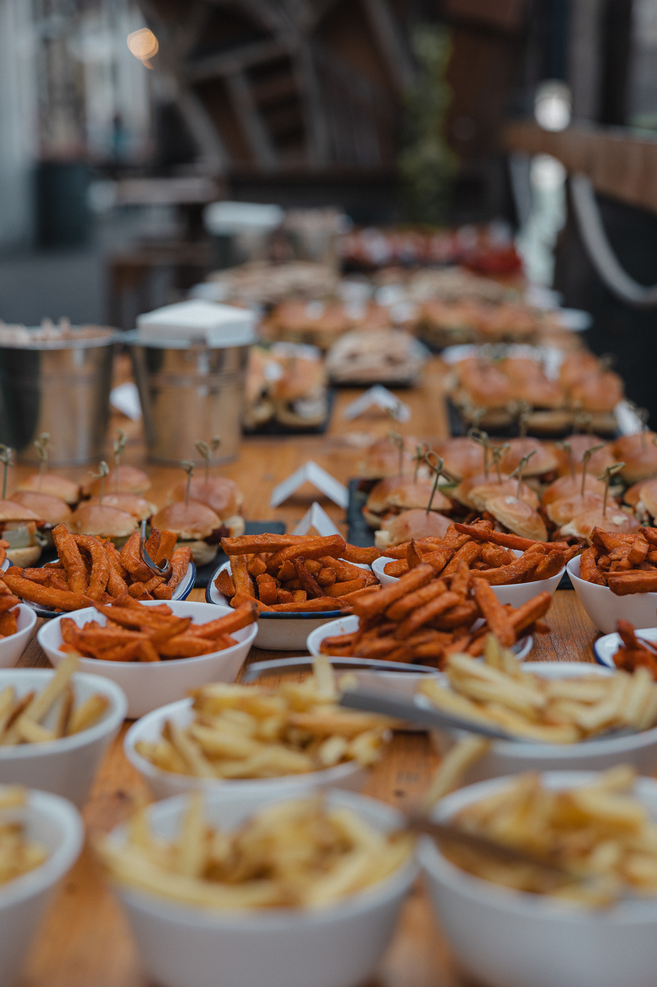 Vibrant buffet of sliders and sweet potato fries at No90 Hackney Wick event.