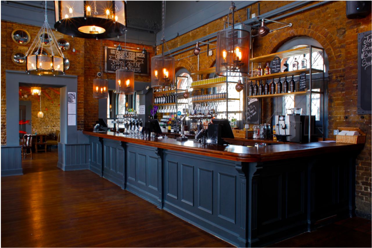 Stylish bar area with exposed brick at Exclusive Hire, perfect for events in Denmark Hill.