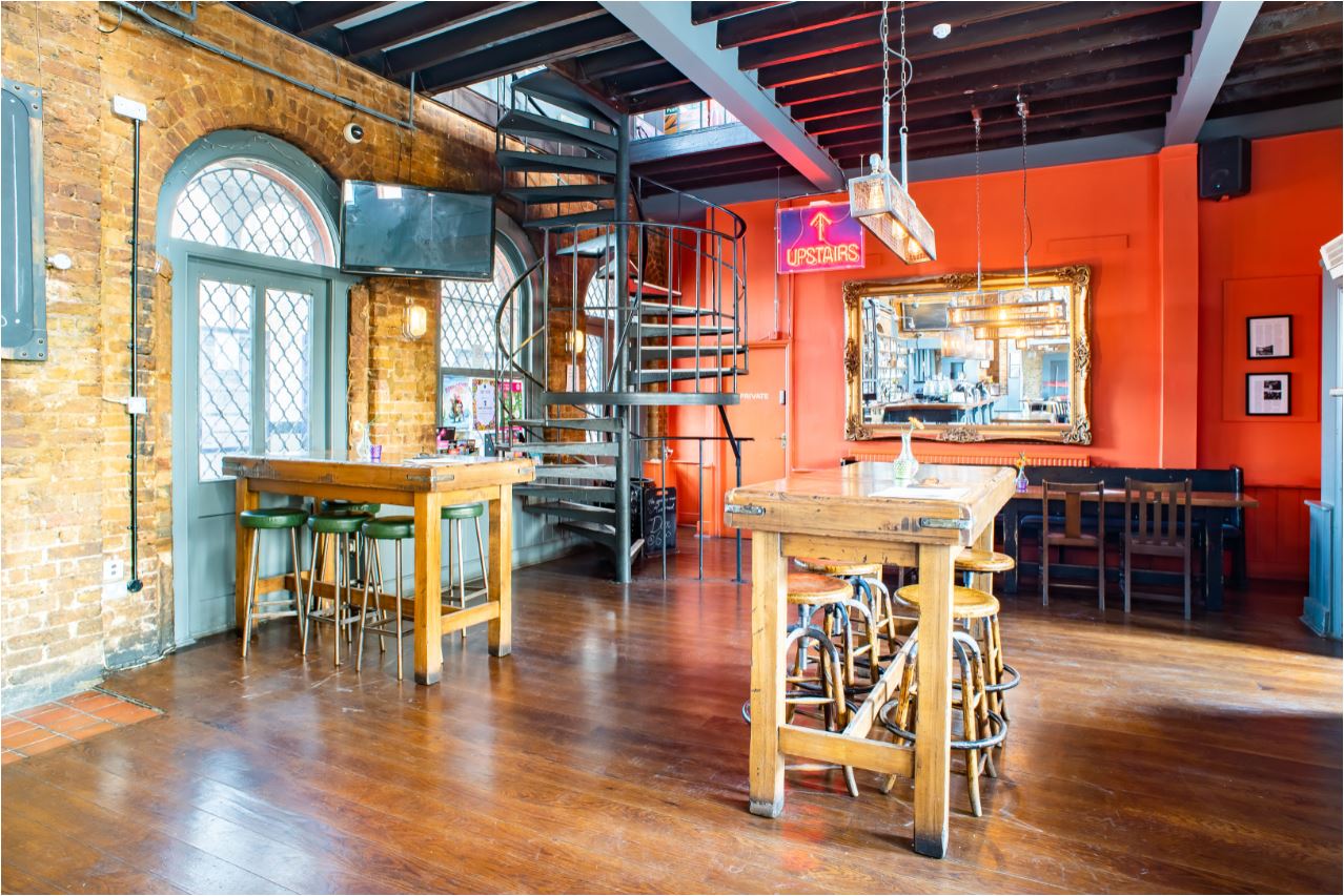 Versatile event space with exposed brick walls at The Phoenix, Denmark Hill for networking events.