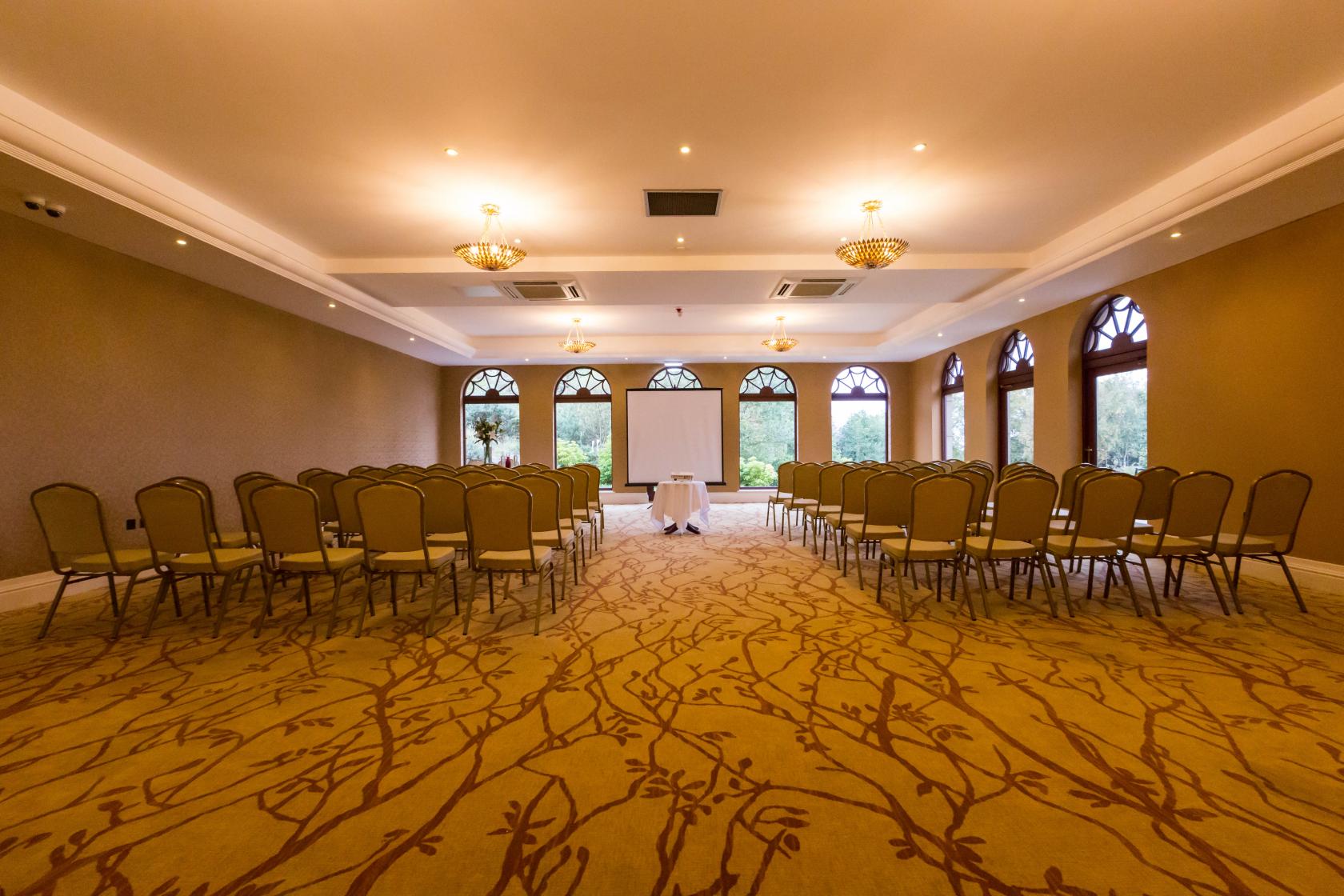 Garden Room at Gleddoch Hotel: spacious meeting room with gold chairs for presentations.