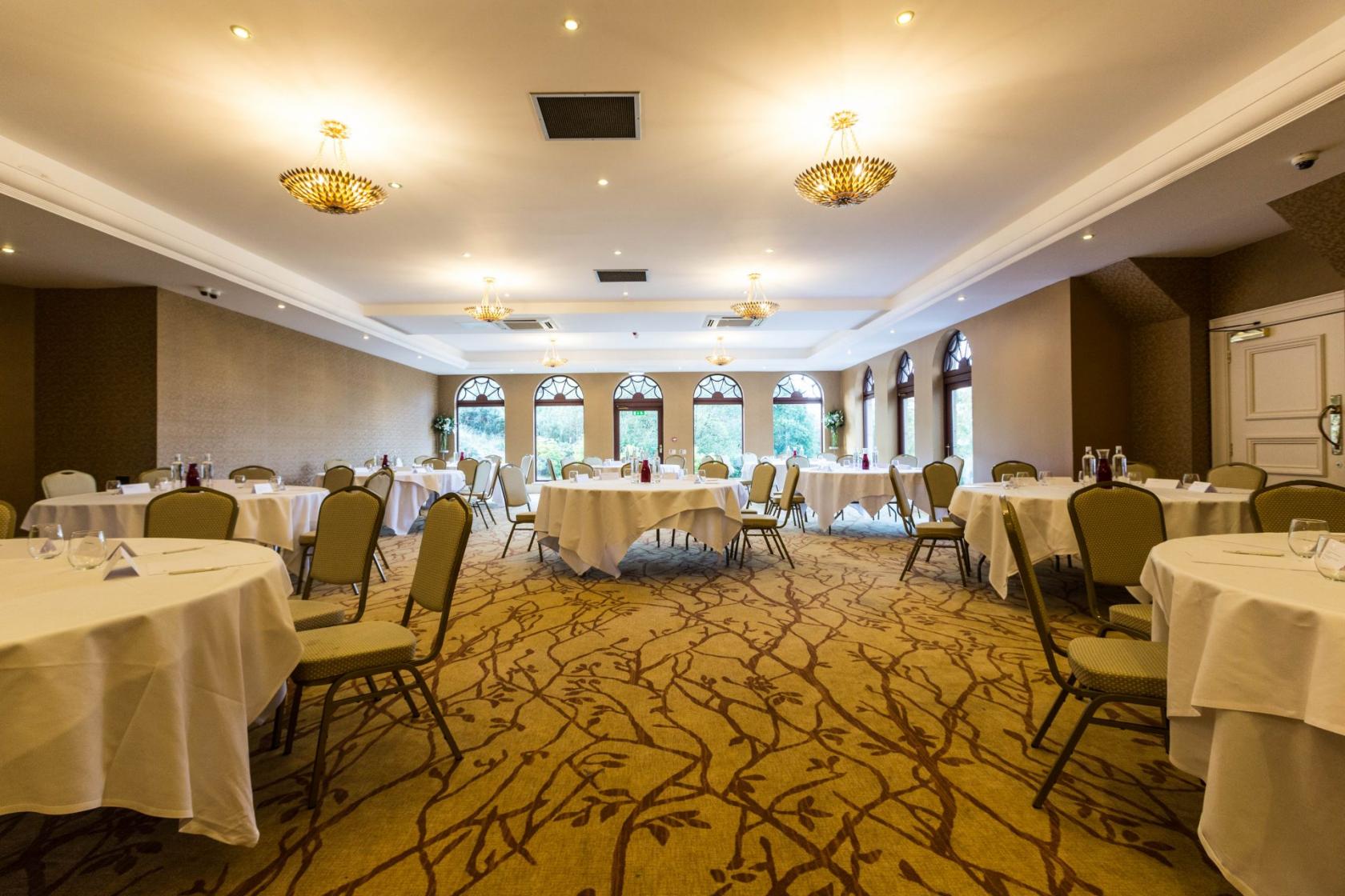 Garden Room at Gleddoch Hotel, elegant event space with round tables for meetings and gatherings.