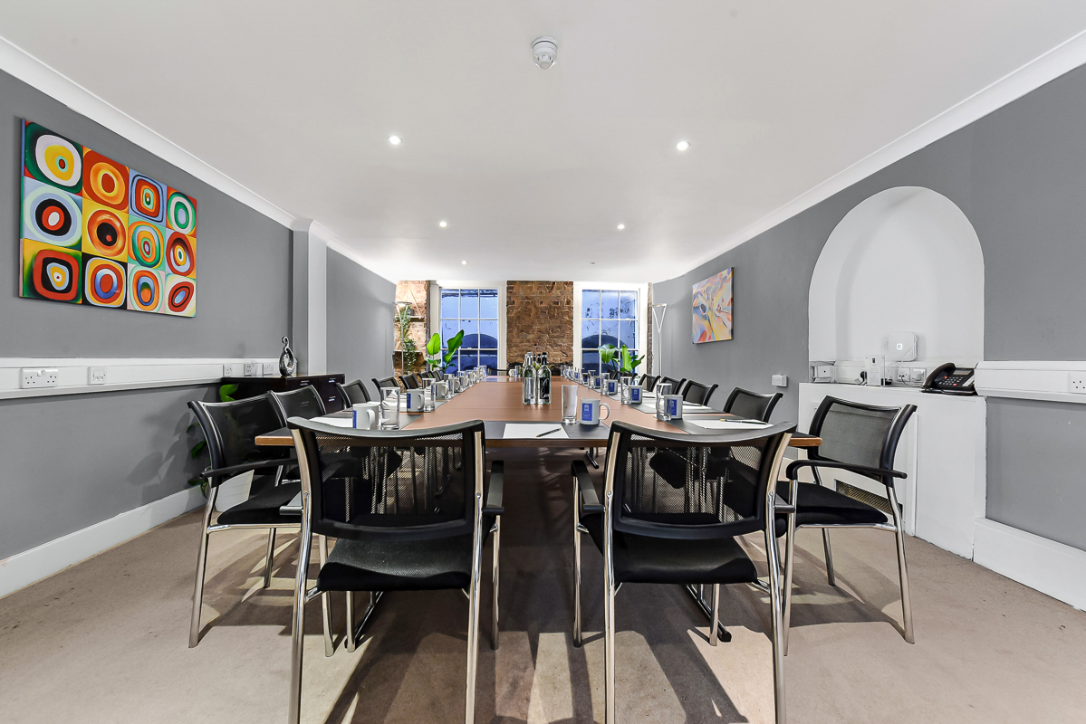 Modern meeting room in Adam House with long table, ideal for collaborative events.