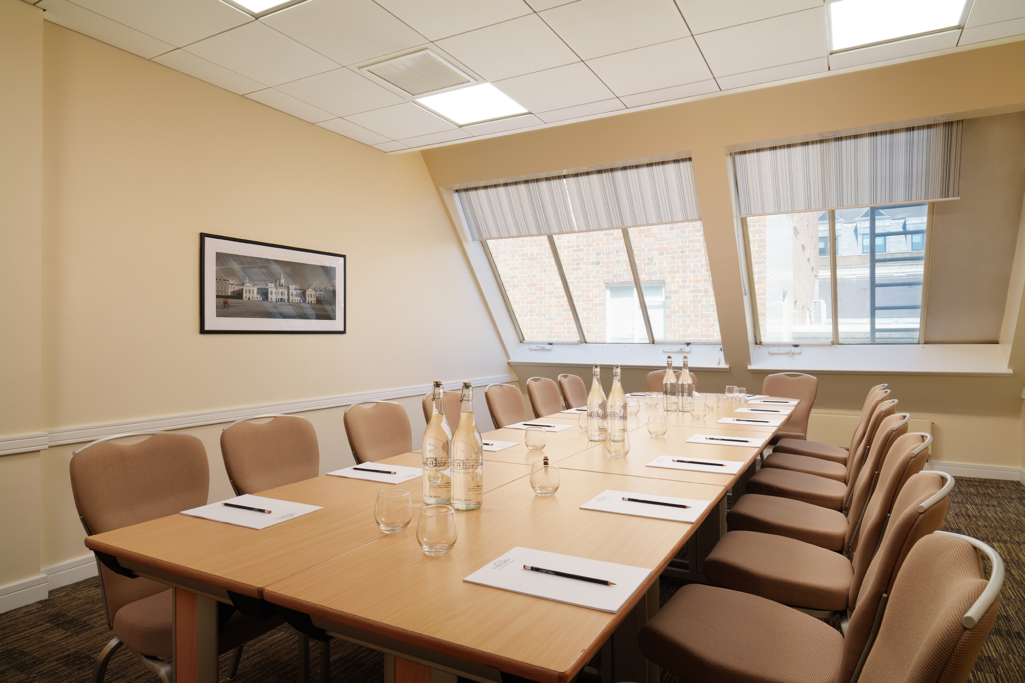 Well-lit meeting room with long table, ideal for workshops and board meetings.