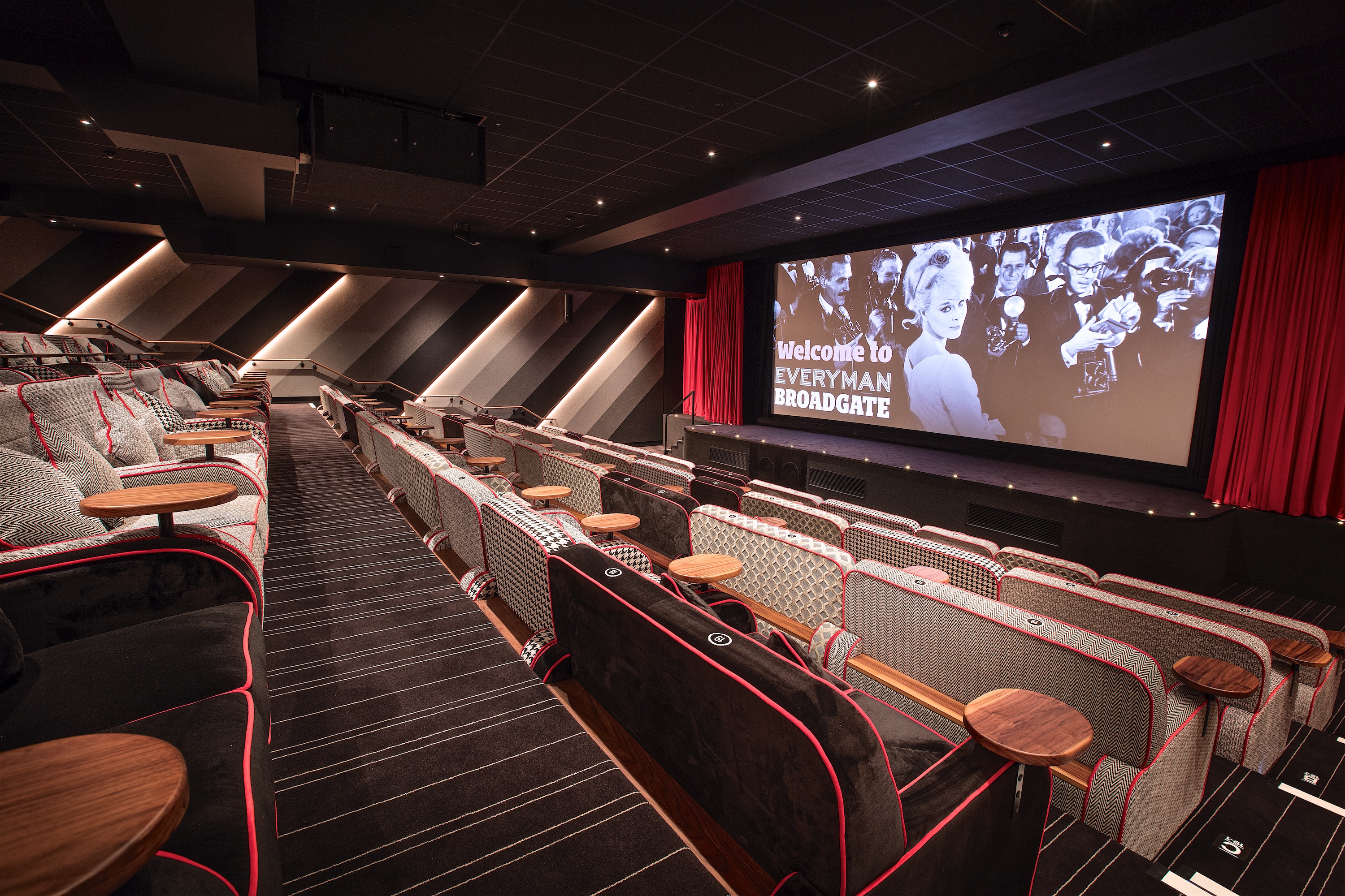 Stylish event space with plush armchairs, ideal for corporate screenings and gatherings.